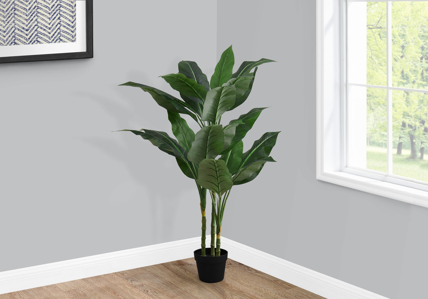 Large artificial palm plant with dark green leaves in a black pot