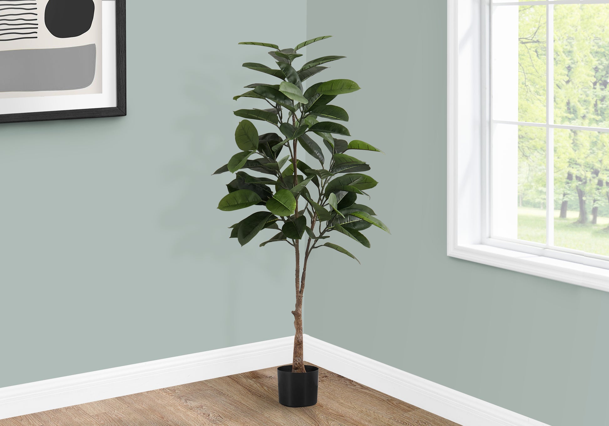 Tall realistic artificial ficus tree with dark green leaves in a black pot for indoor decor