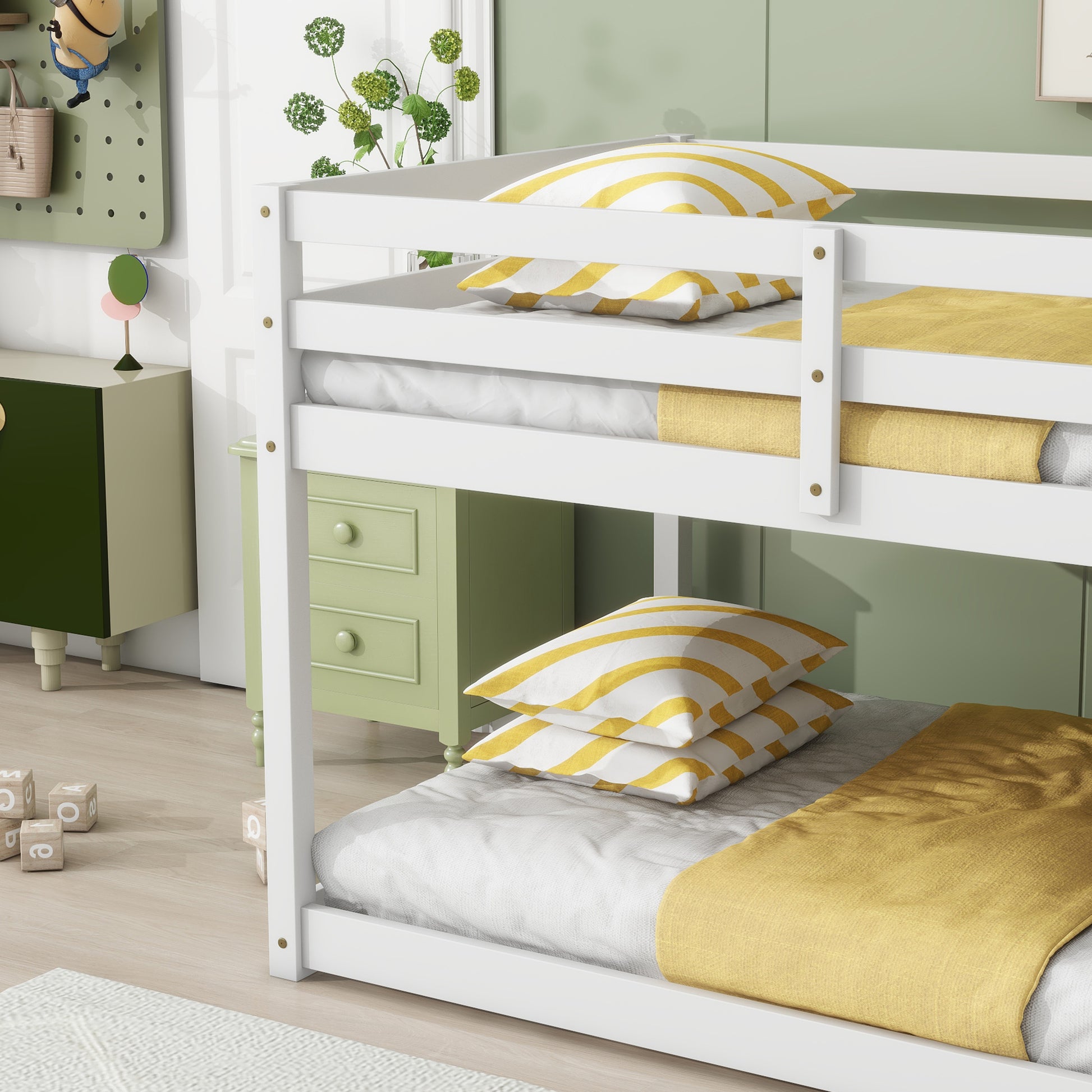 White wooden bunk bed with yellow striped pillows and mustard blankets