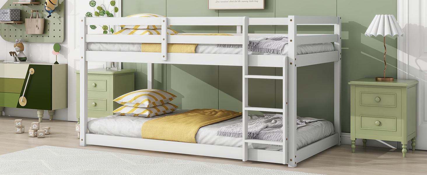 White wooden twin bunk bed with yellow striped pillows and blankets