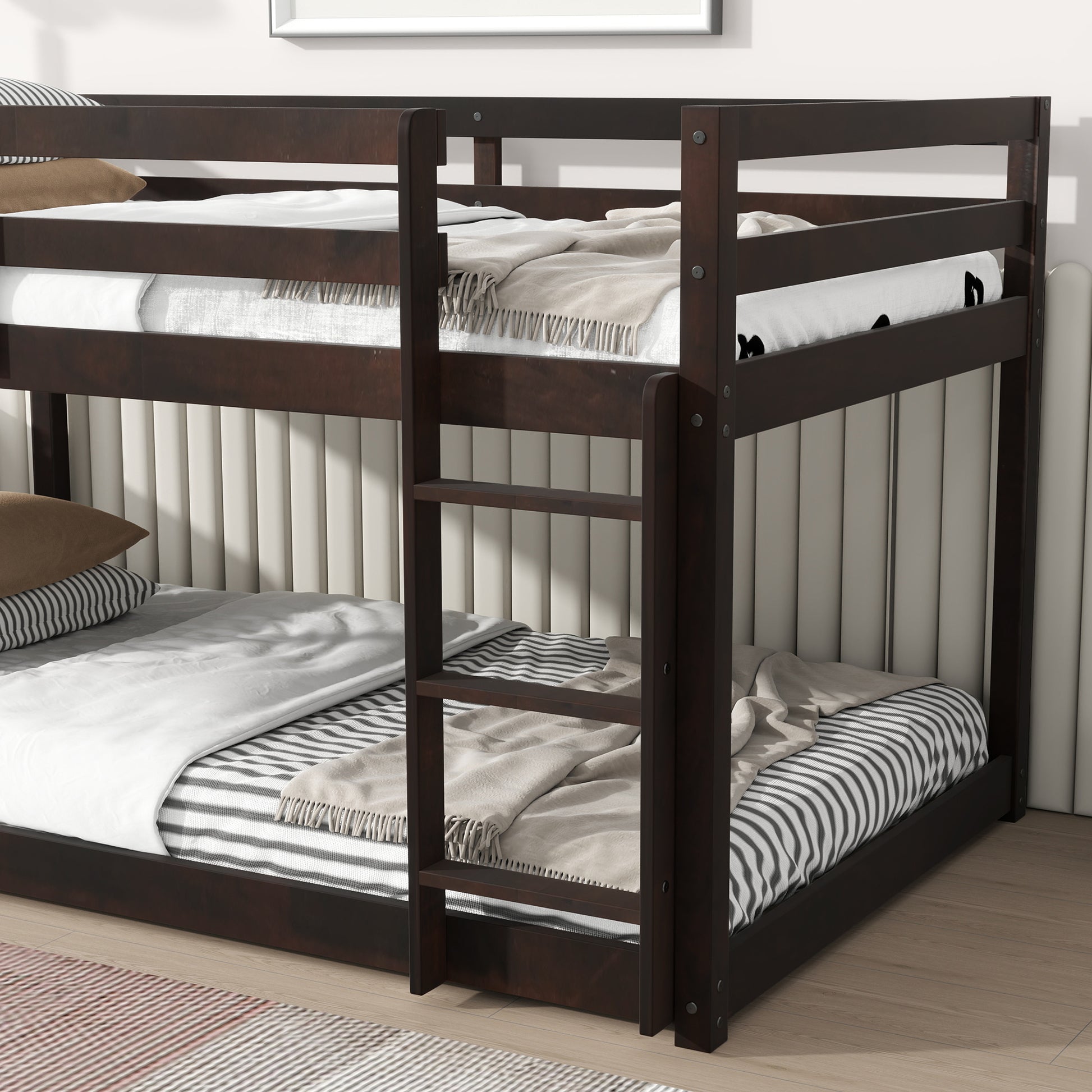 Dark wood bunk bed with white linens and striped blankets