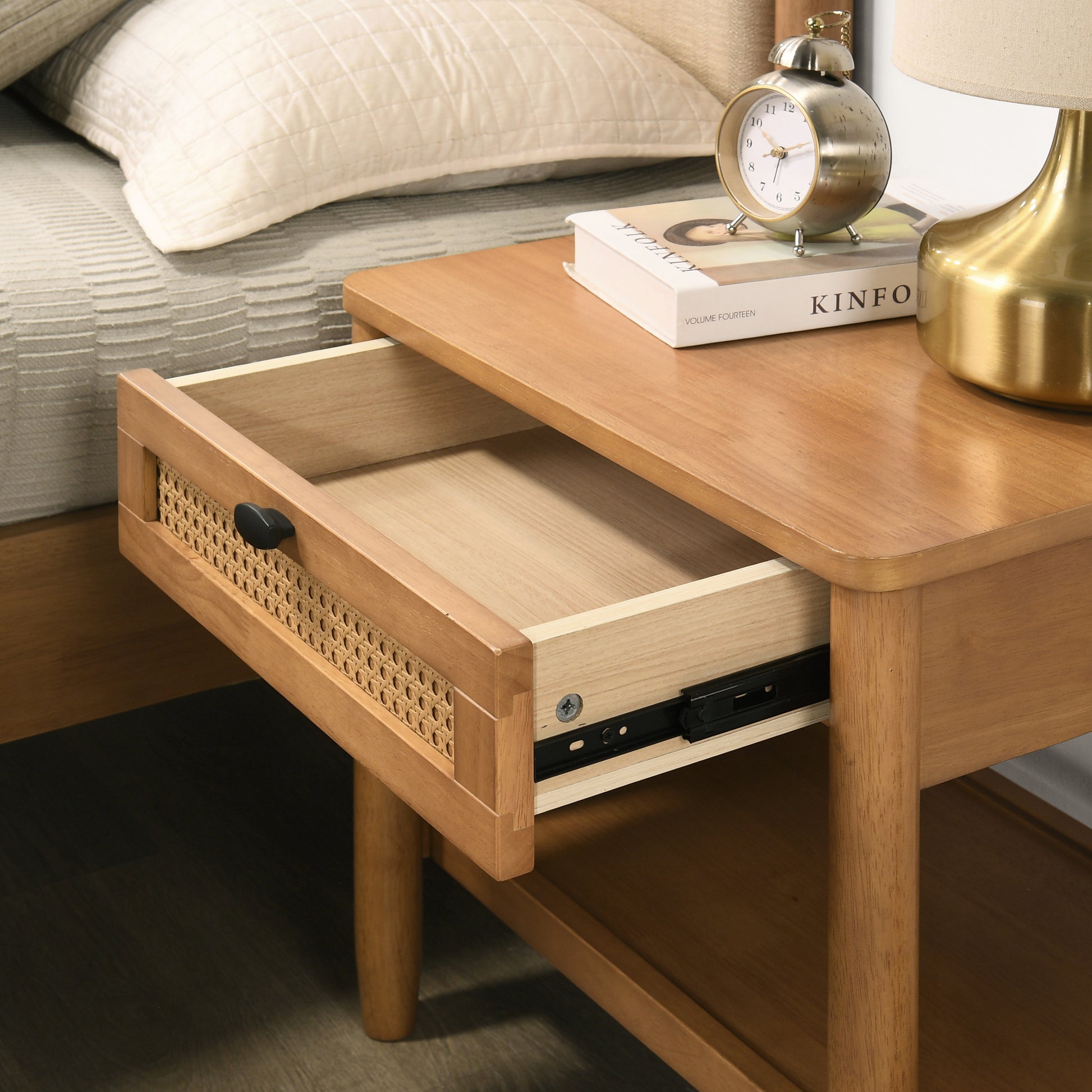Natural wood nightstand with cane drawer front and open drawer revealing storage
