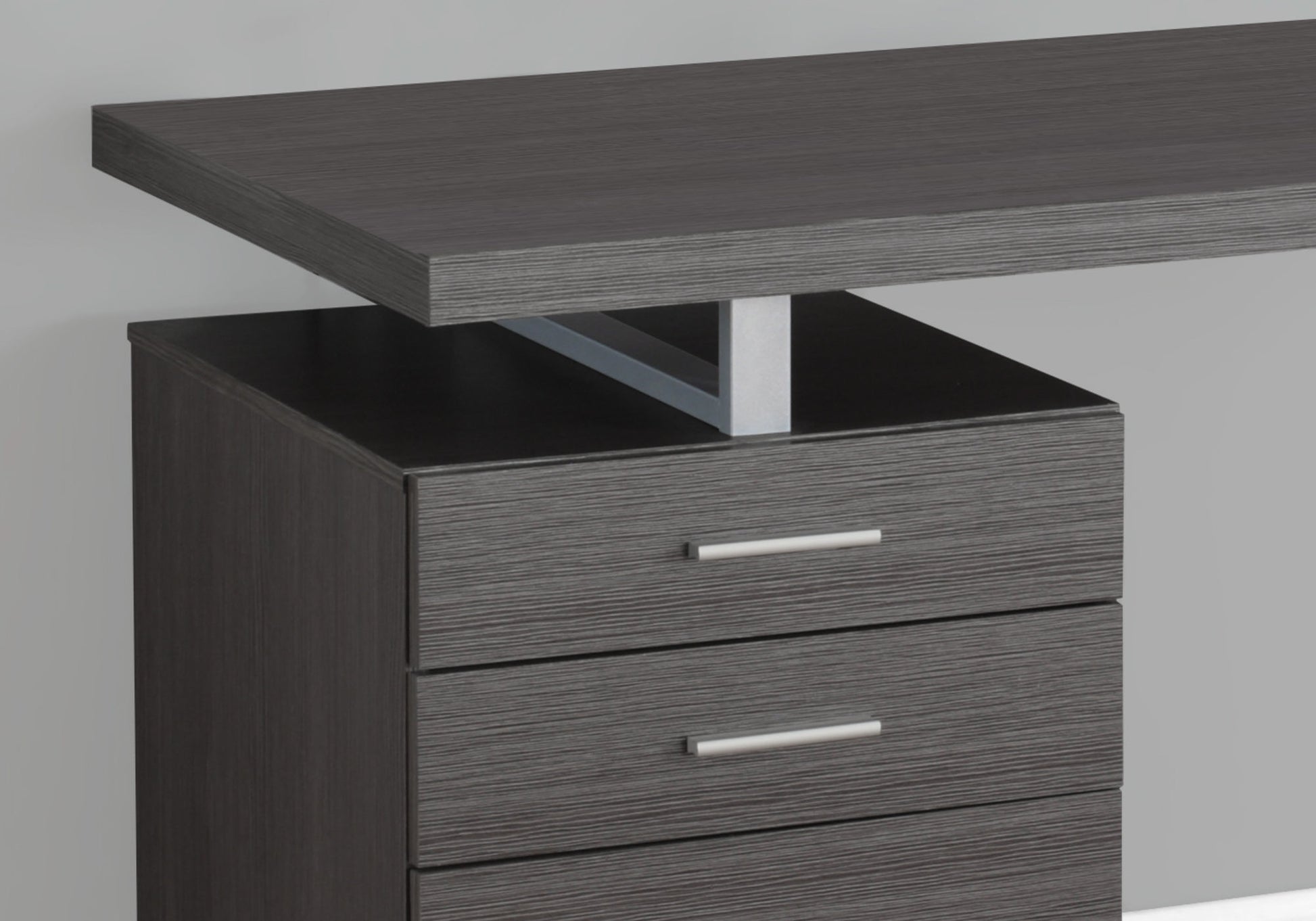 Modern dark gray desk with three drawers and a floating top perfect for home office