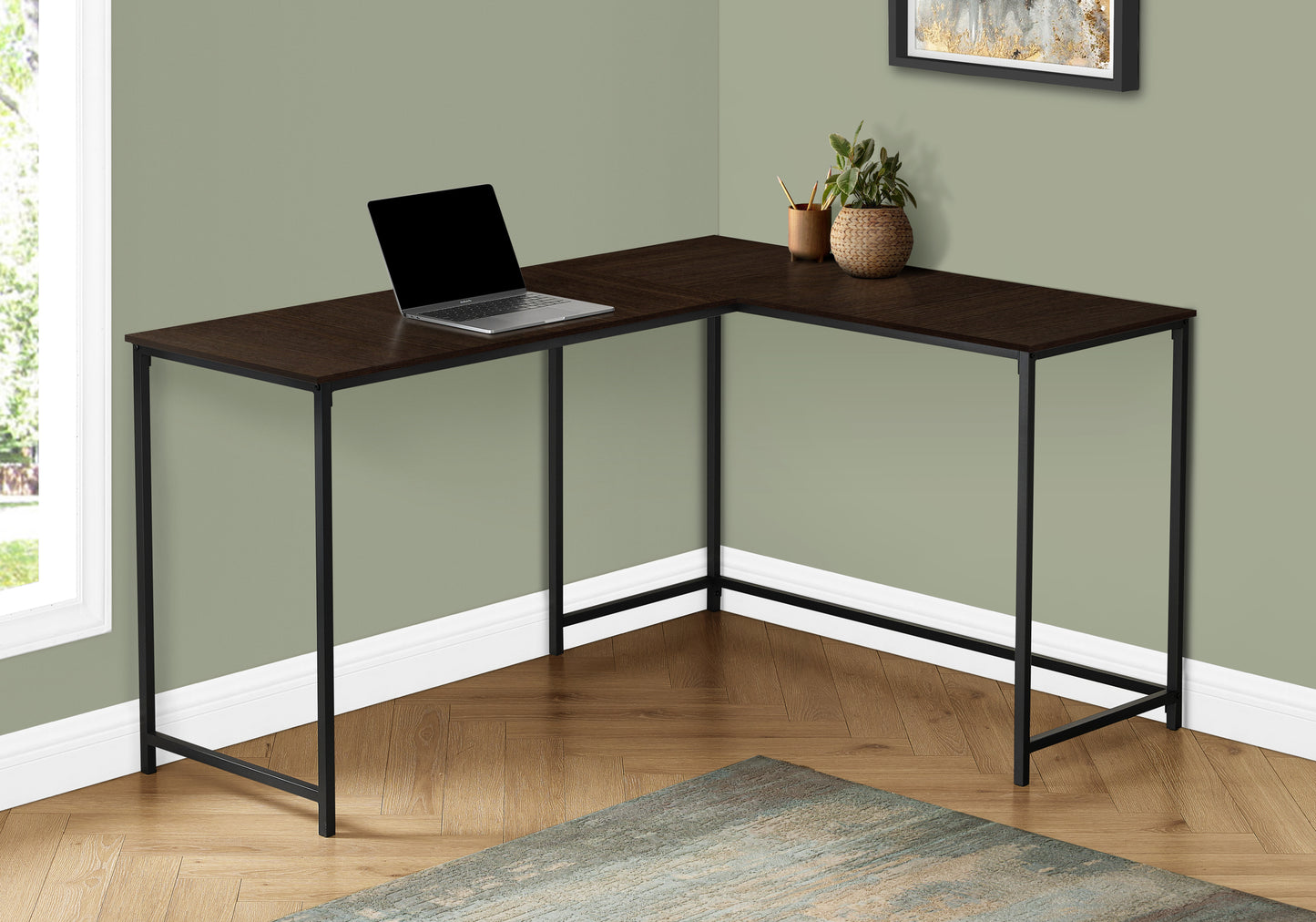 Dark espresso corner desk with metal legs featuring a laptop and plant on surface