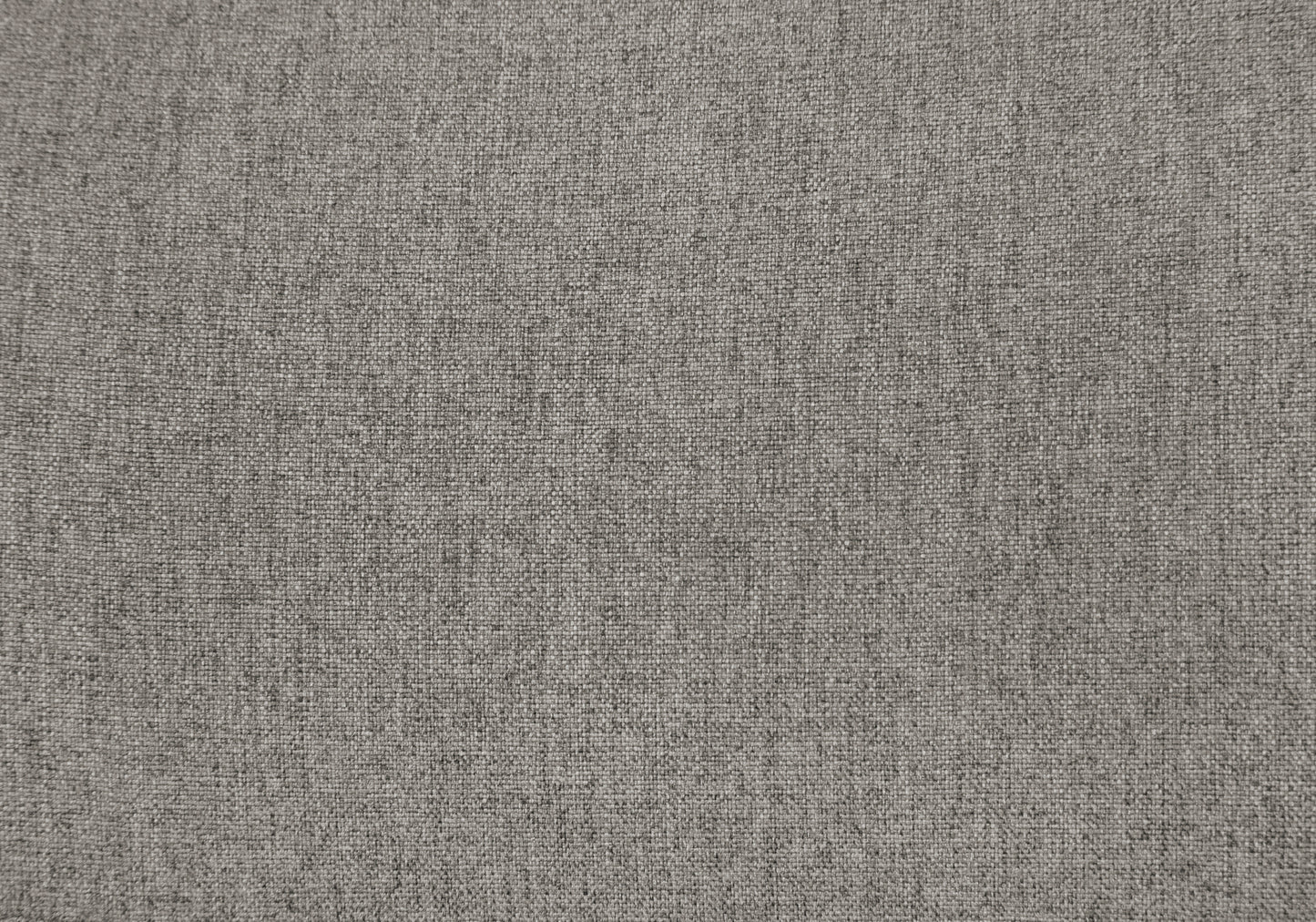Closeup of grey textured upholstery fabric with a visible weave pattern