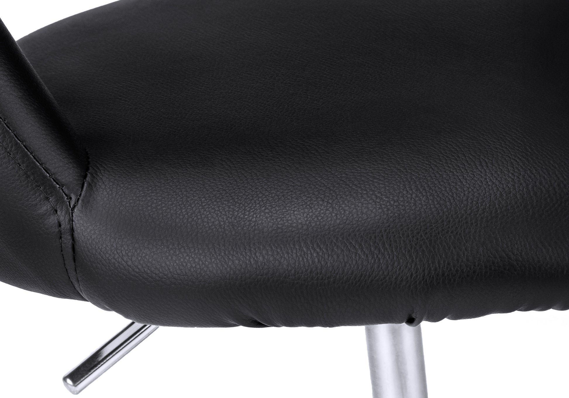 Closeup of black faux leather seat cushion with visible stitching and a chrome support leg ideal for modern home decor