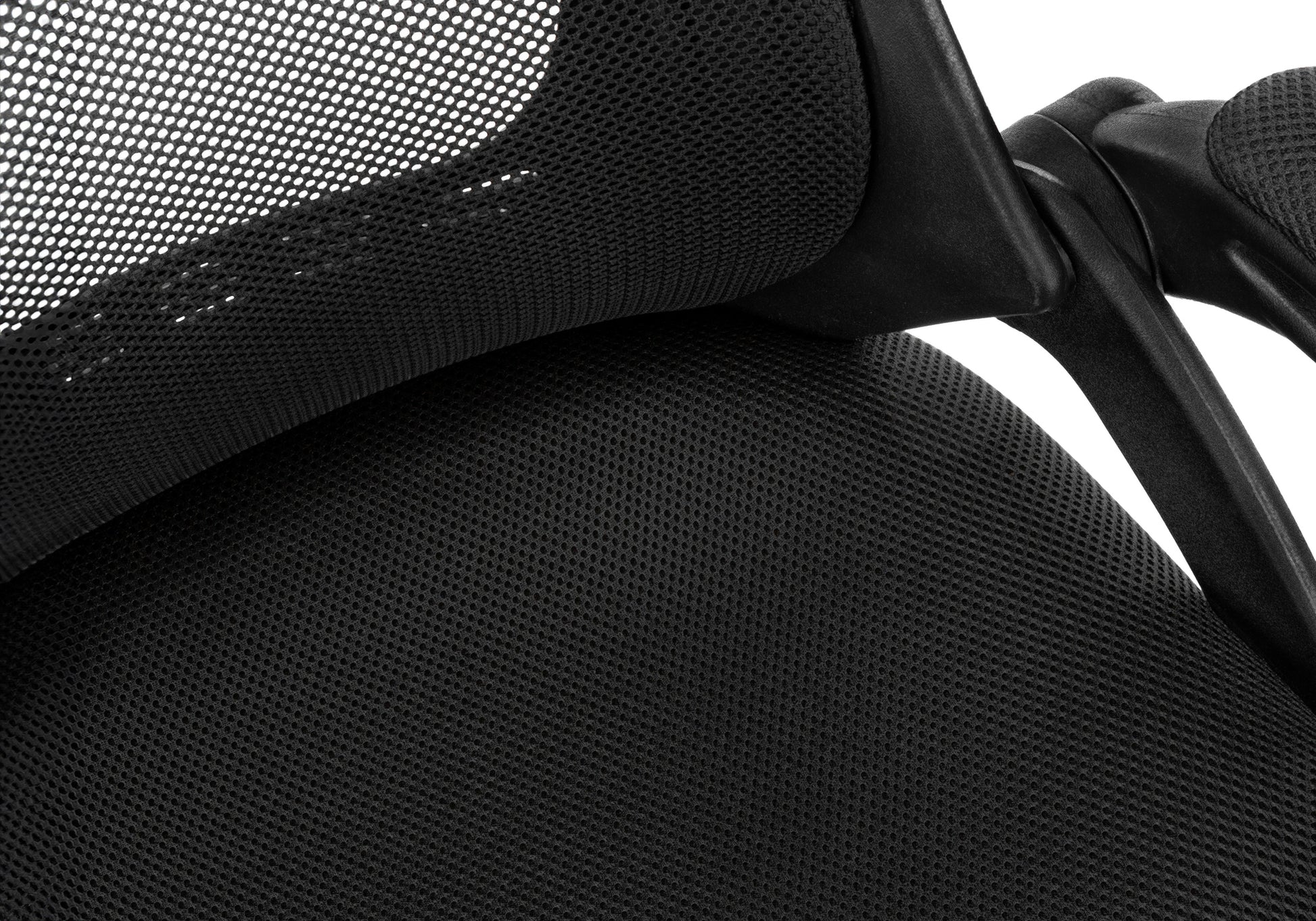 Closeup of black mesh fabric on an office chair backrest