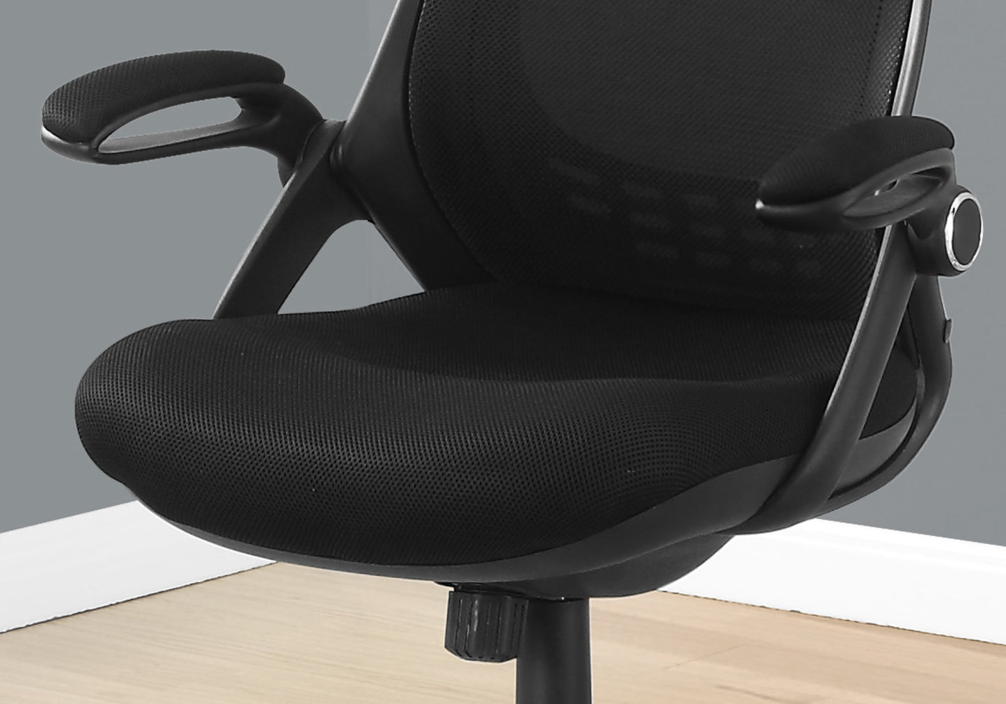 Black mesh ergonomic office chair with padded armrests