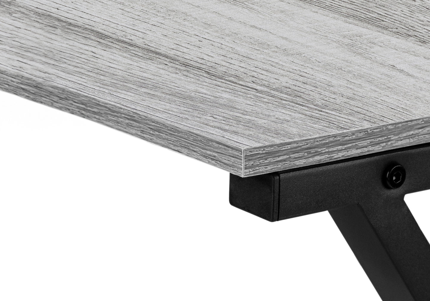 Closeup of a grey wood grain desk surface with black metal leg support