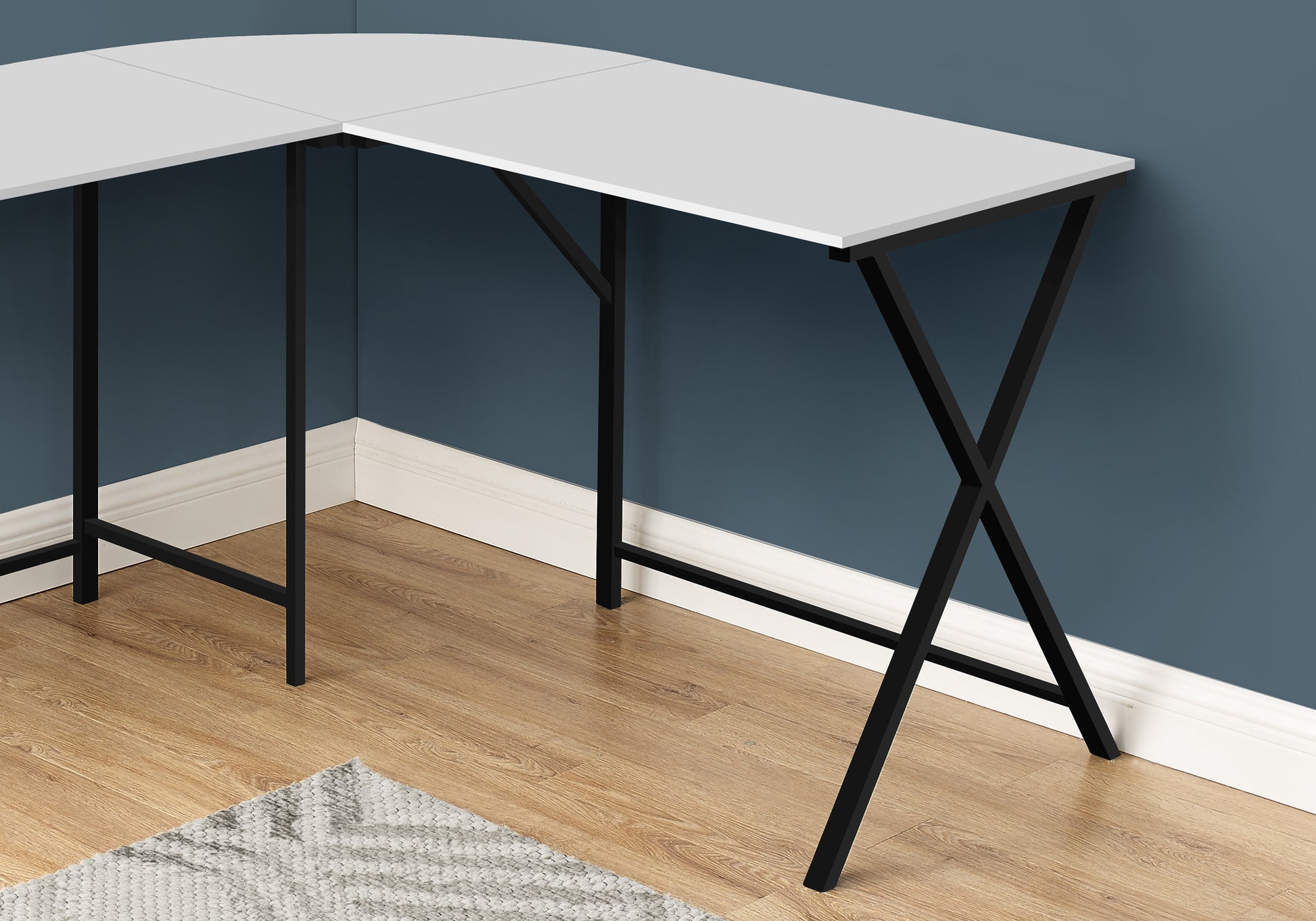 White Lshaped desk with black metal legs ideal for home office setup