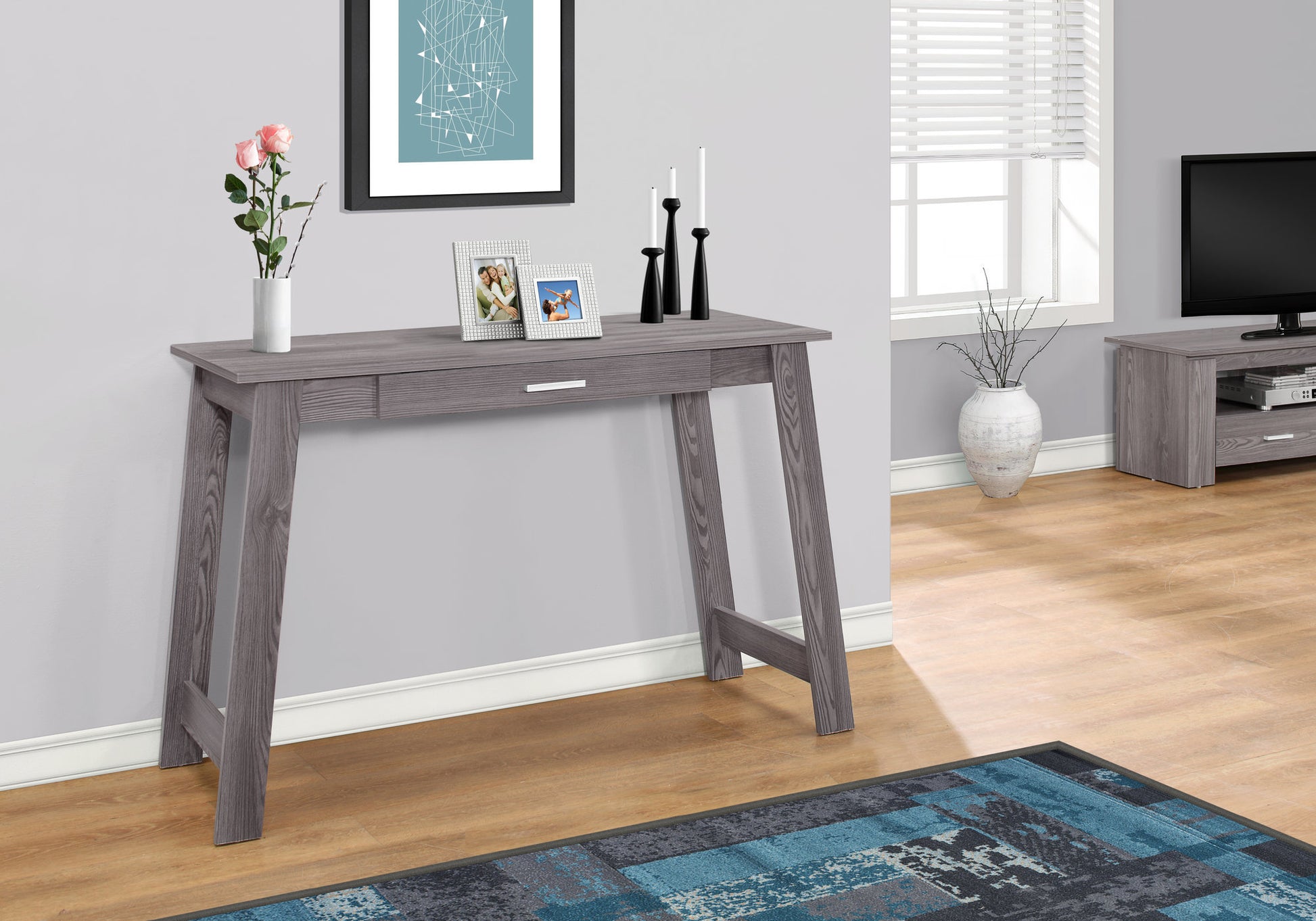 Gray wood console table with one drawer and decorative items