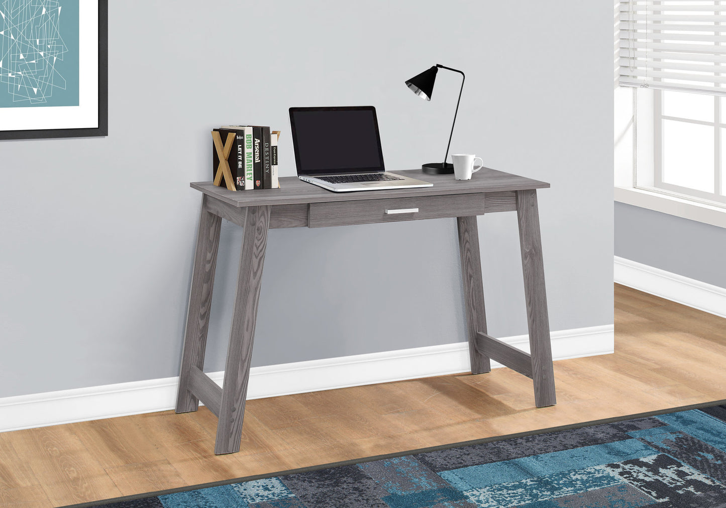 Gray wooden desk with drawer laptop lamp and mug