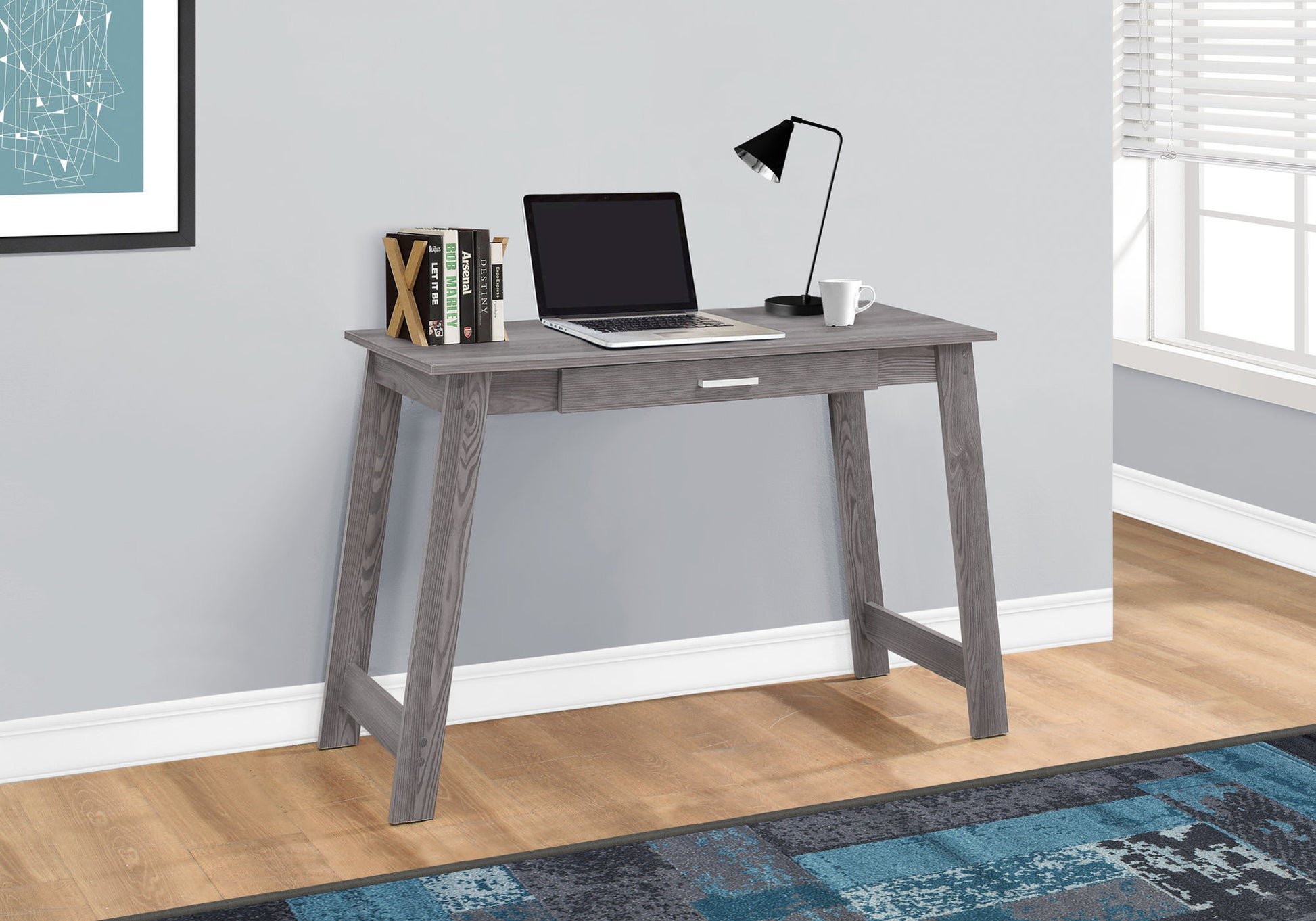 Gray wooden desk with drawer laptop lamp and mug
