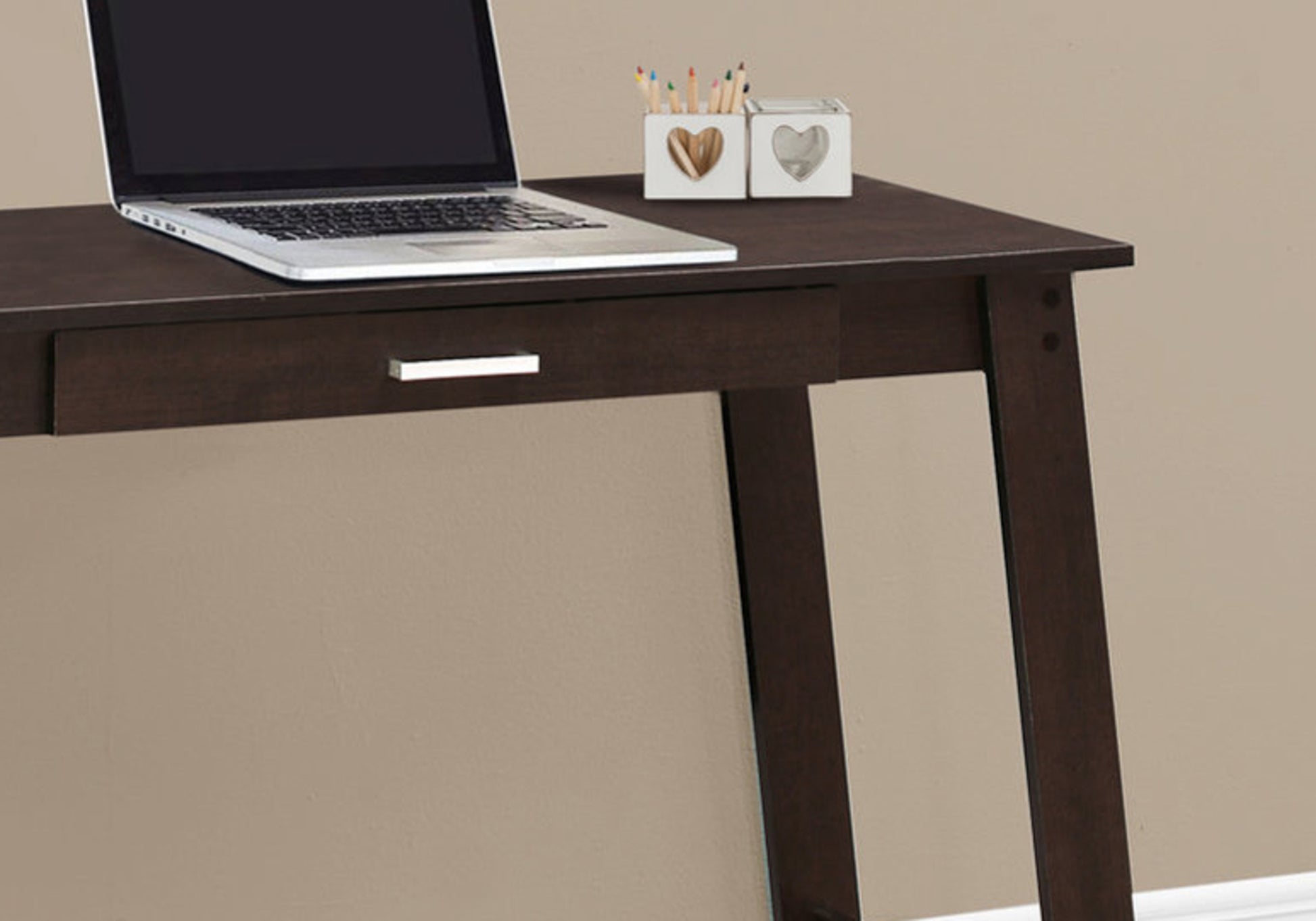 Dark brown modern writing desk with silver drawer pull and laptop