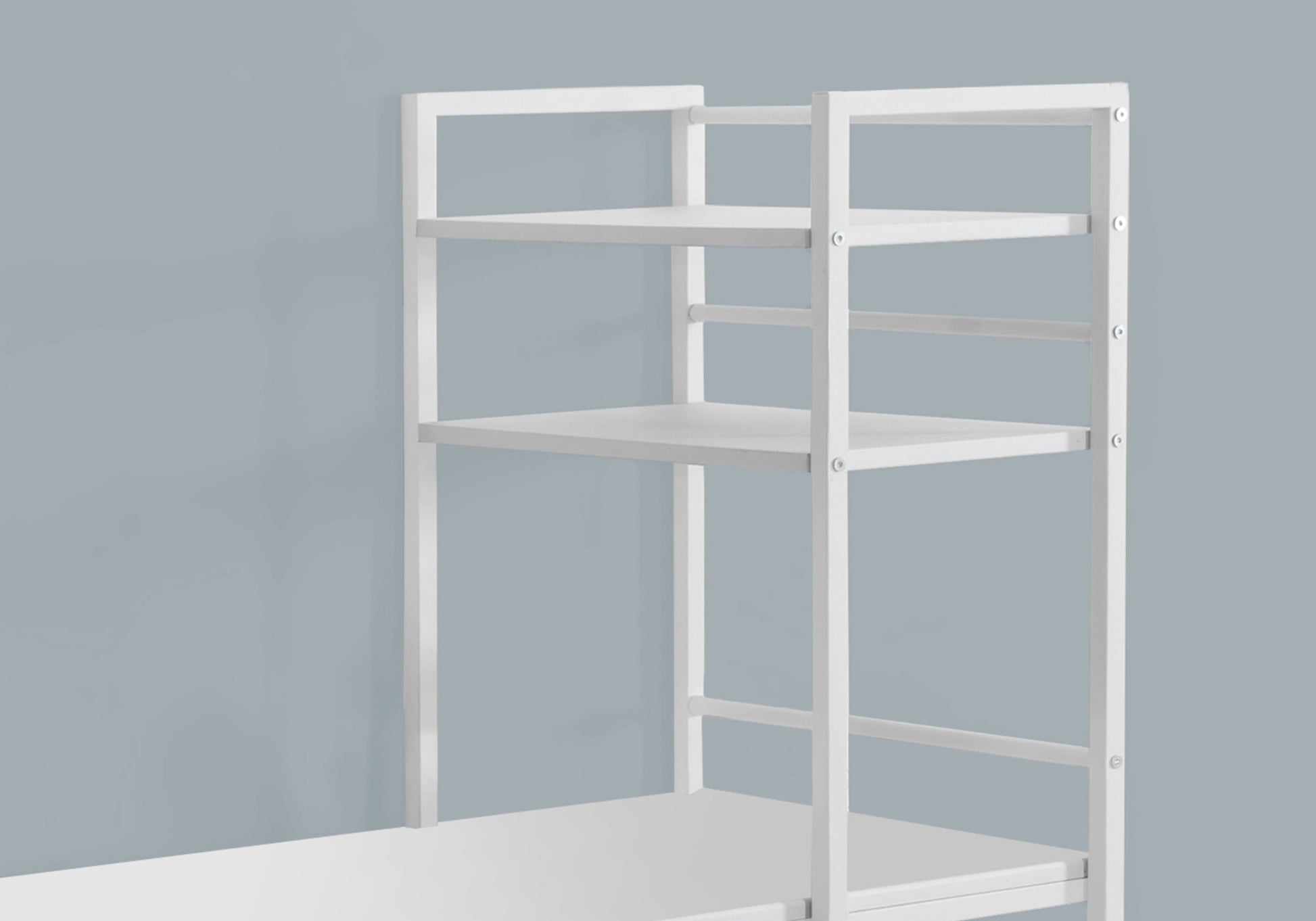 White metal shelving unit with three open shelves for storage