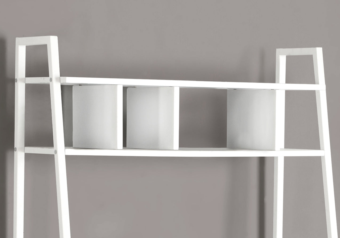 White leaning bookshelf with three cube compartments on a shelf ideal for modern homes