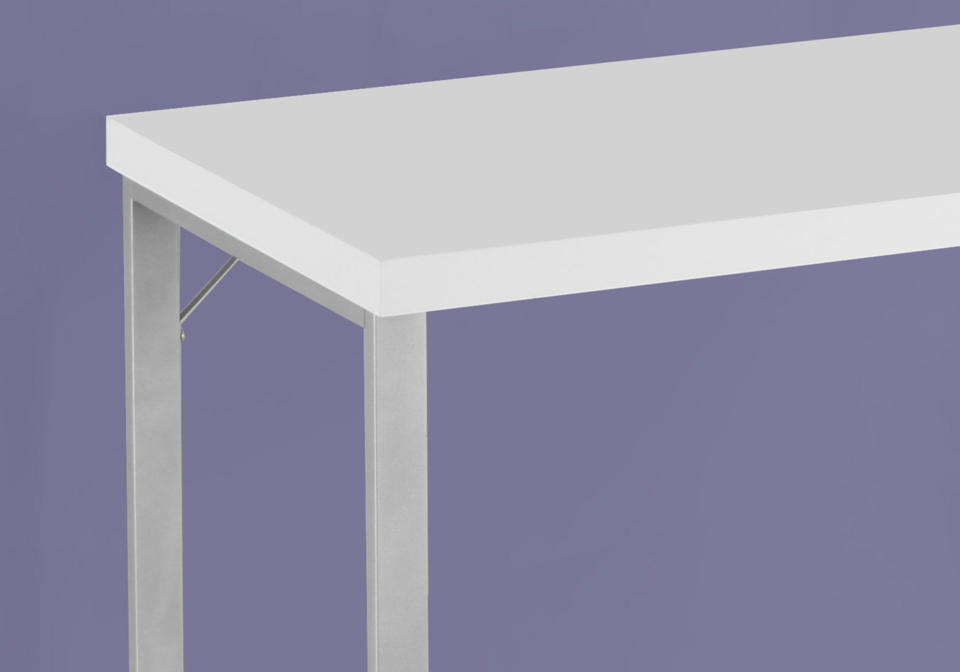 Minimalist white desk with sleek silver metal legs perfect for modern home offices