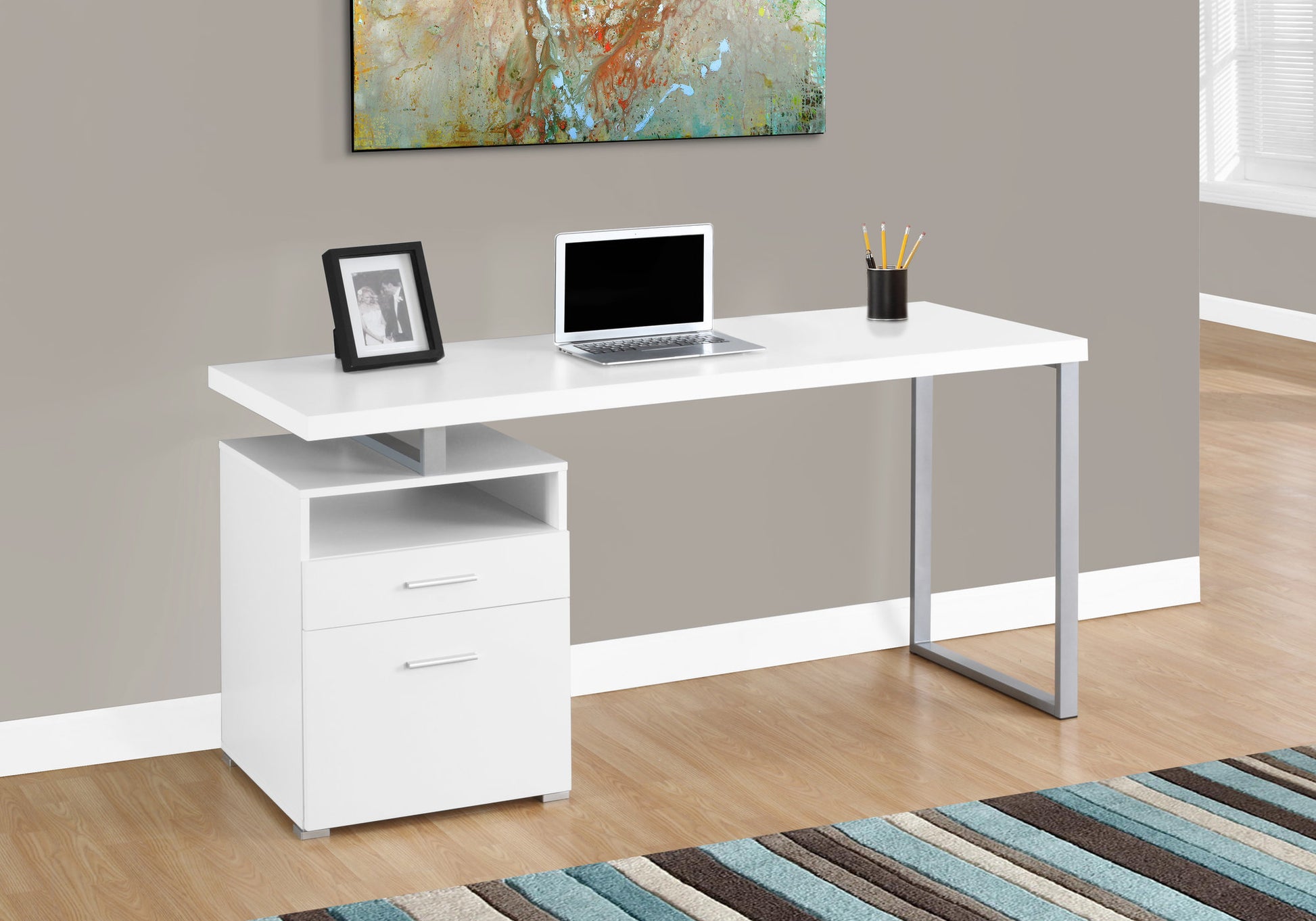 Sleek white modern desk with silver legs and integrated drawers perfect for a home office setup