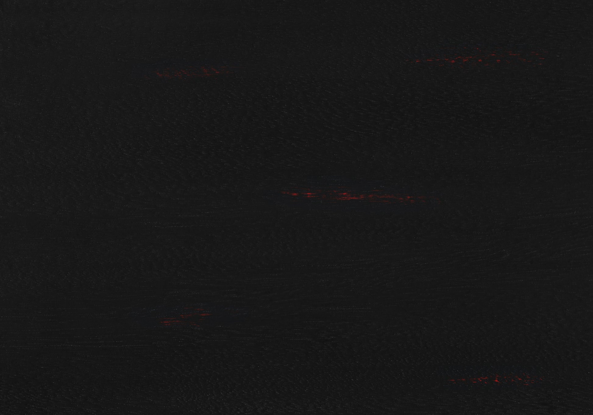Textured black faux leather swatch with subtle red flecks for upholstery
