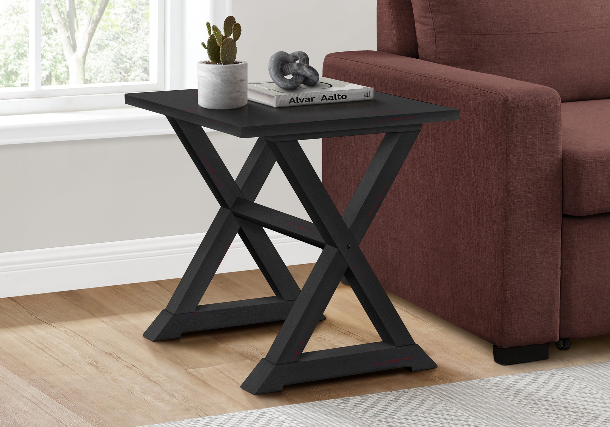 Black wooden Xleg side table with distressed red accents perfect for small spaces