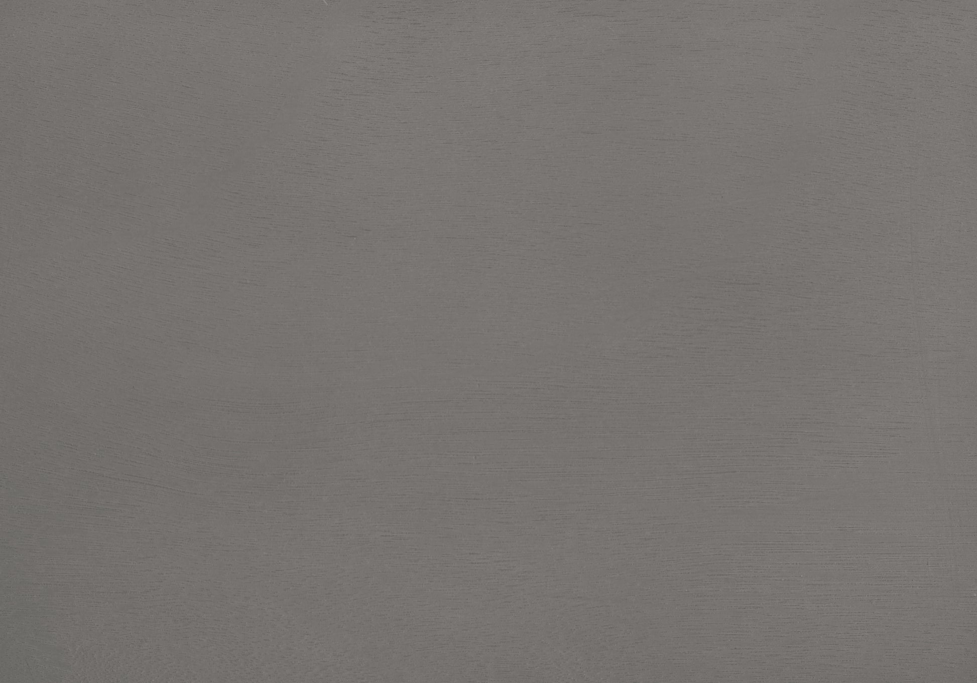 Closeup of textured matte gray paint on a smooth surface