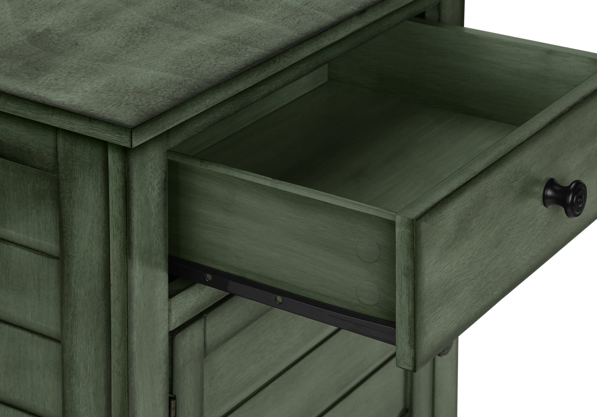 Green wooden cabinet with open drawer and black knob
