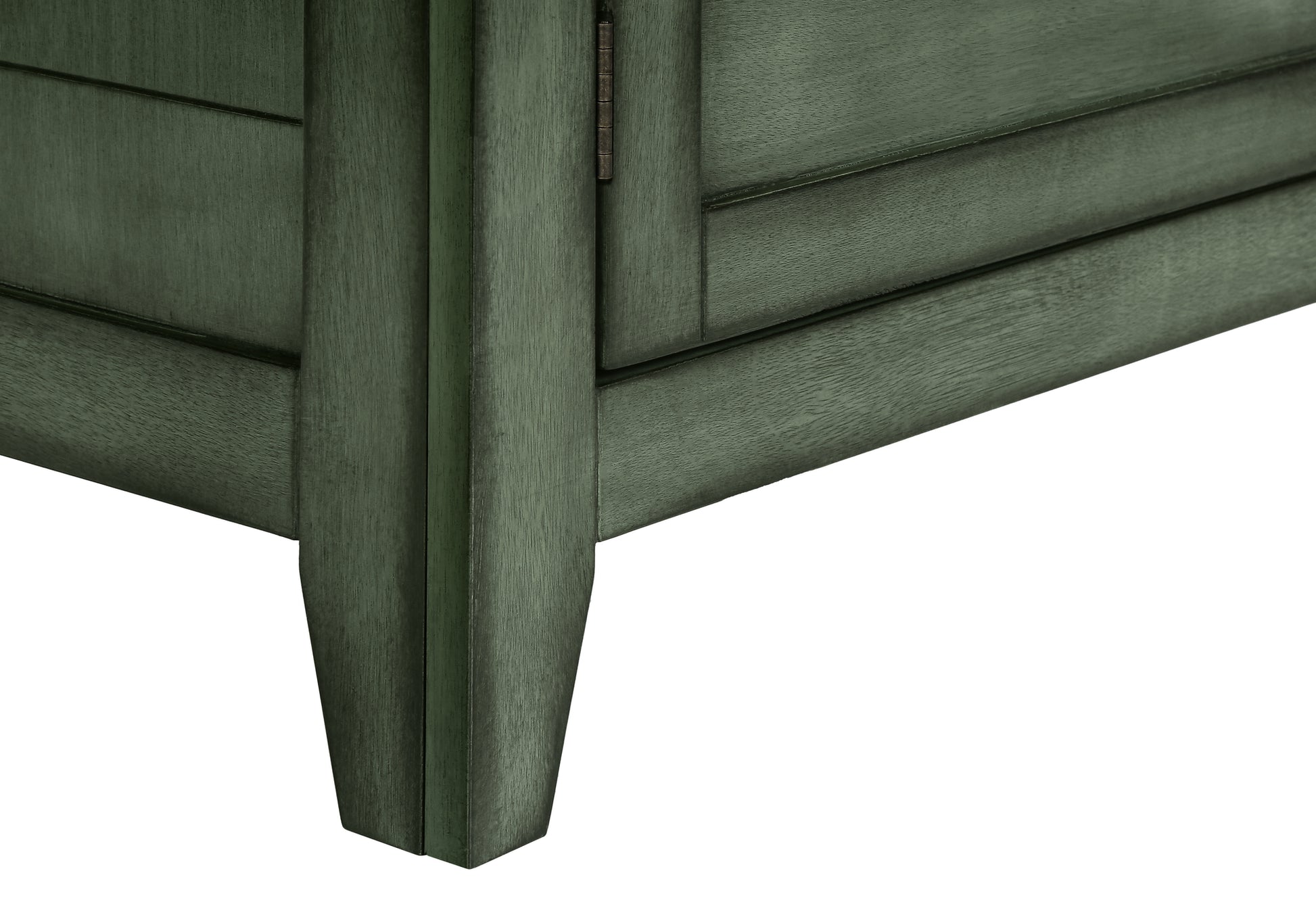 Closeup of a dark green wooden cabinet leg and panel with a visible hinge