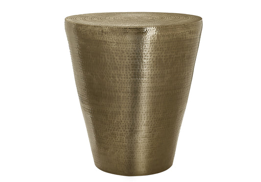 Hammered antique brass drum side table with tapered base and textured surface