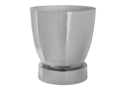 Textured silver metal accent table with hammered finish and tapered body