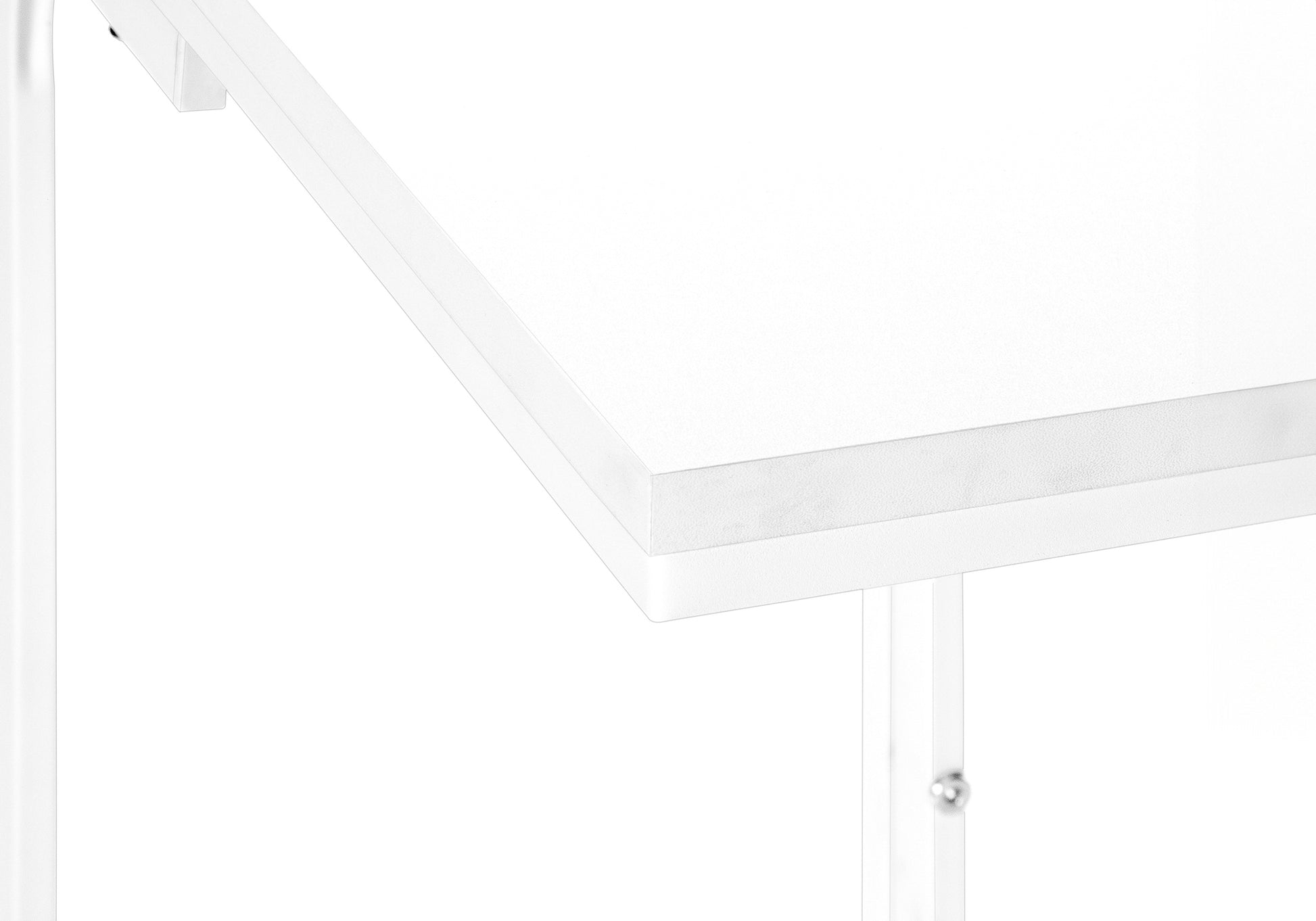 Closeup of white desk edge with metal leg detail