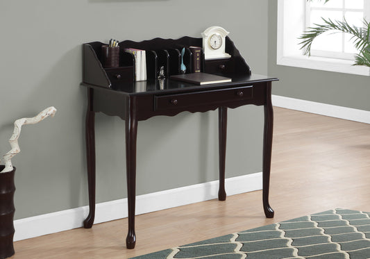 Dark wood secretary desk with scalloped top and ornate legs holding books and a clock