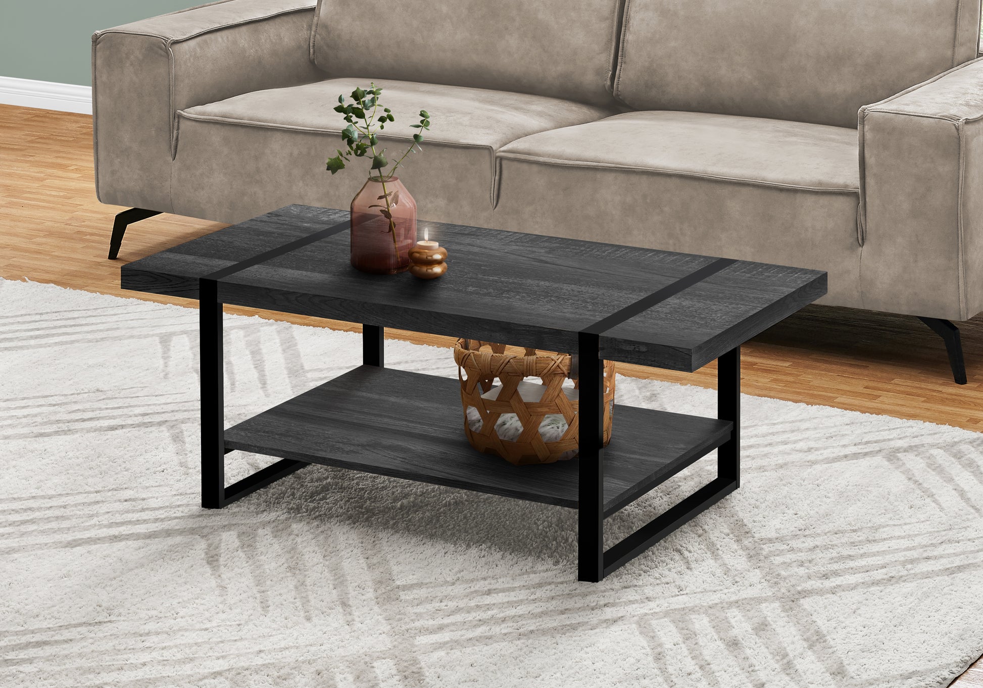 Dark wood rectangular coffee table with black metal frame and dual shelves holding decor items