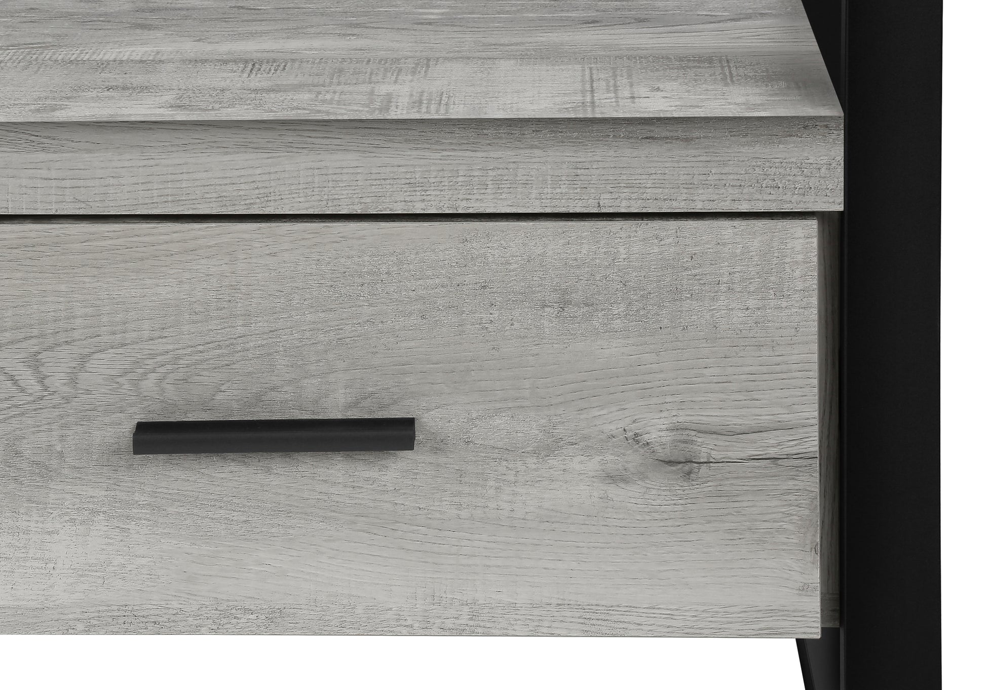 Rustic grey wood grain texture on a drawer front with a black handle