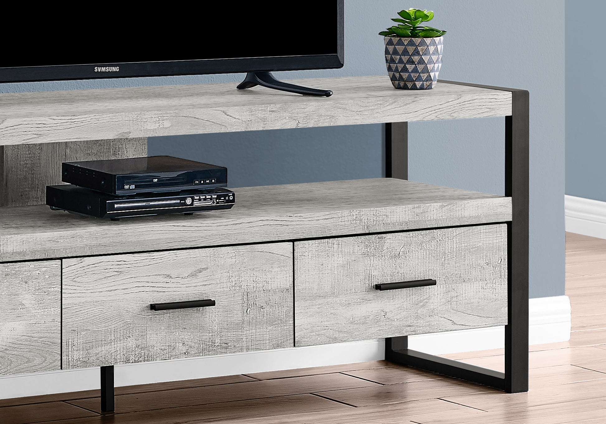 Gray wood grain TV stand with black metal frame and two drawers