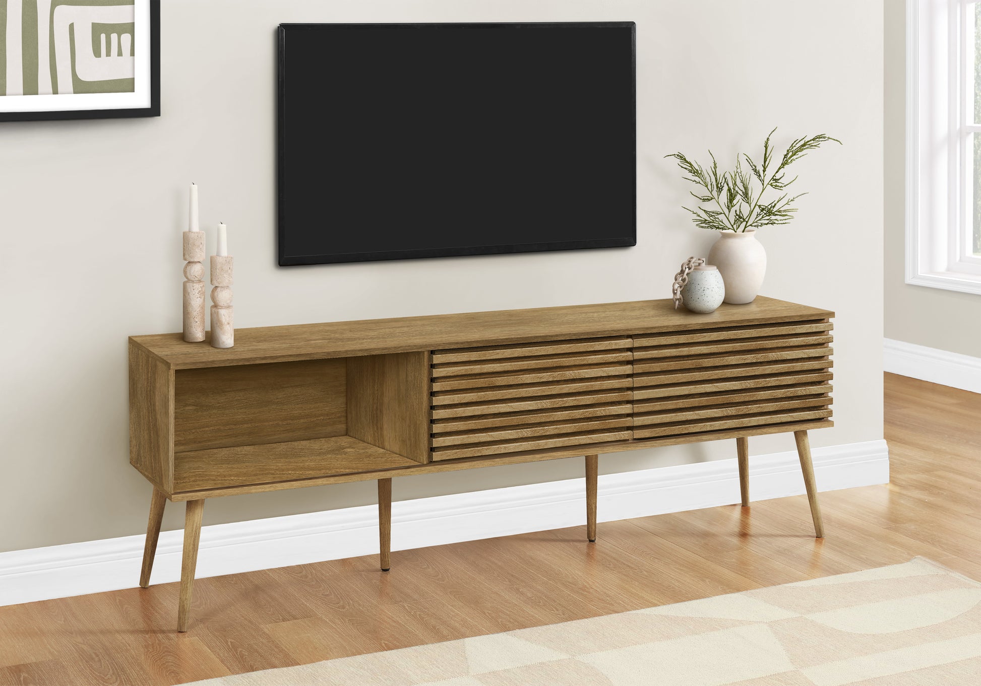 Midcentury modern TV stand in warm oak finish with slatted doors and open shelving
