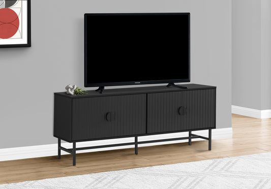 Modern black media console with fluted doors and metal legs
