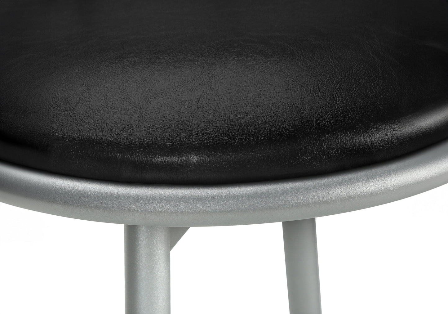Black faux leather seat cushion on a silver metal frame stool closeup