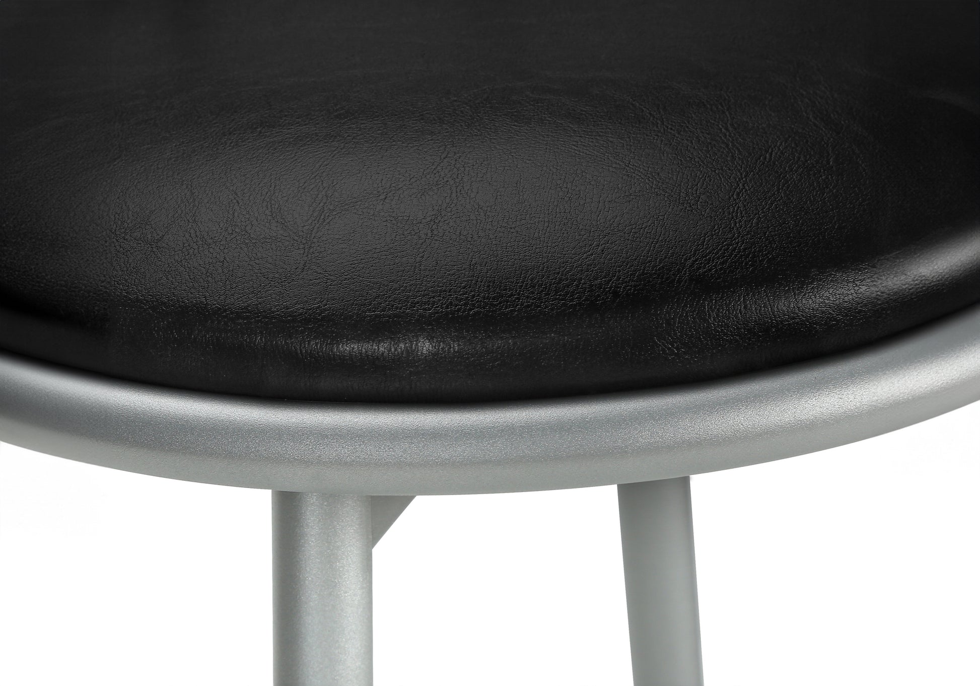 Black faux leather seat cushion on a silver metal frame stool closeup