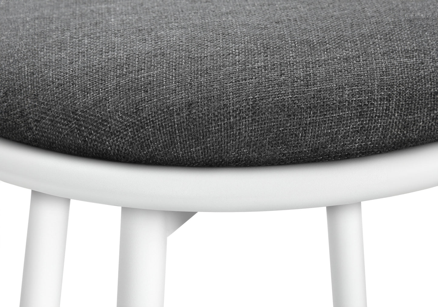 Closeup of a textured dark grey fabric seat on a white minimalist stool