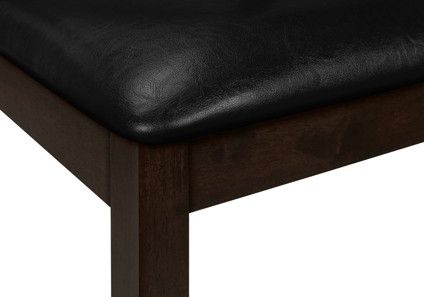 Closeup of a black leather upholstered seat with a dark wood frame highlighting the texture