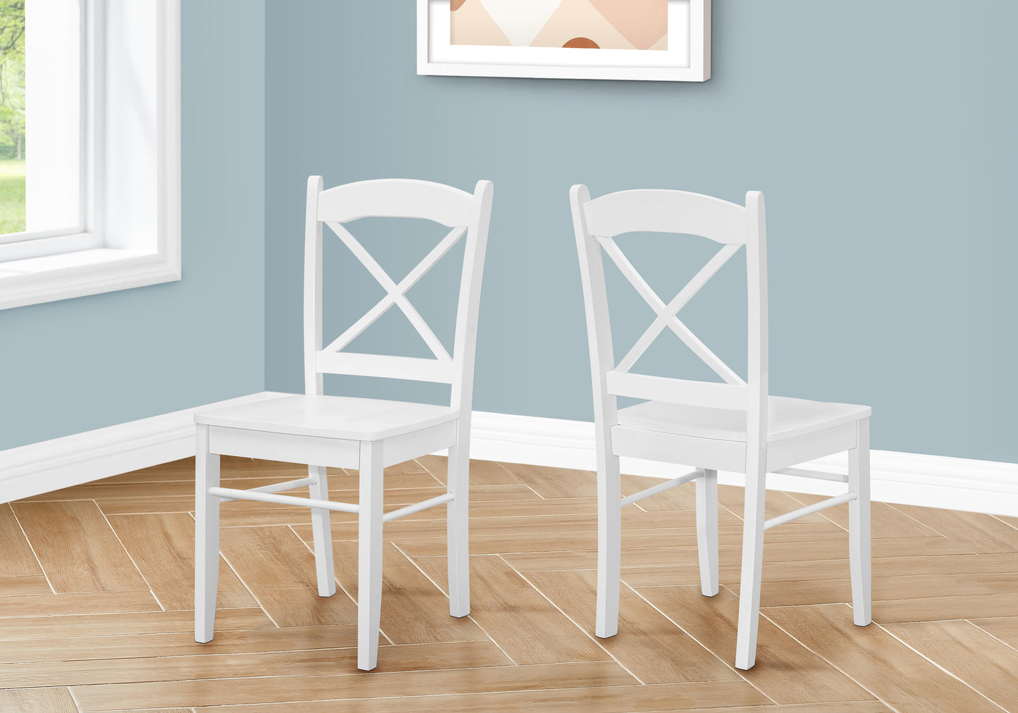 Two white wooden dining chairs with Xback design perfect for a farmhouse kitchen