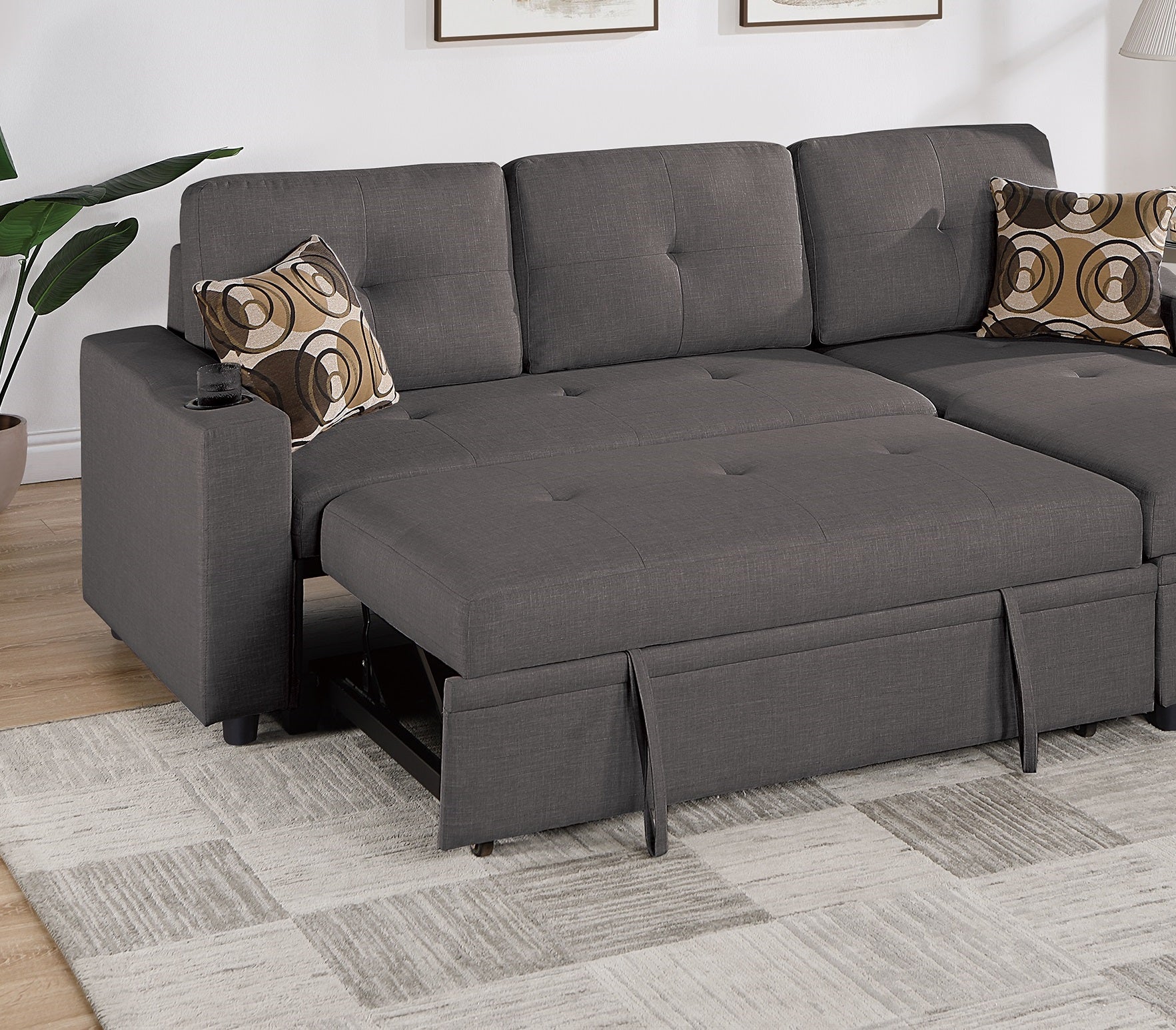 Dark grey sectional sofa bed with pullout storage and builtin cup holder