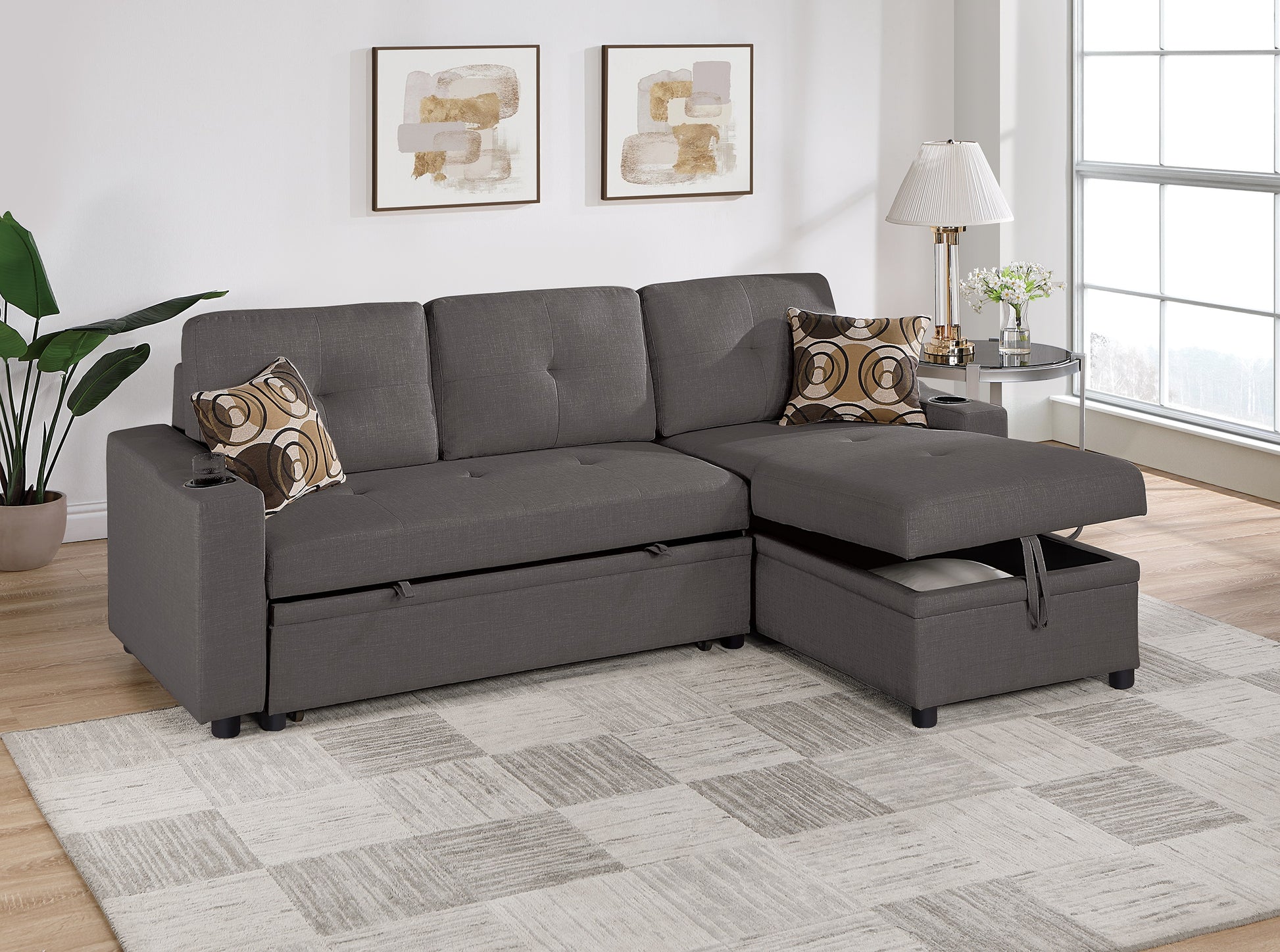 Dark gray fabric sectional sofa with chaise lounge featuring hidden storage and cup holders