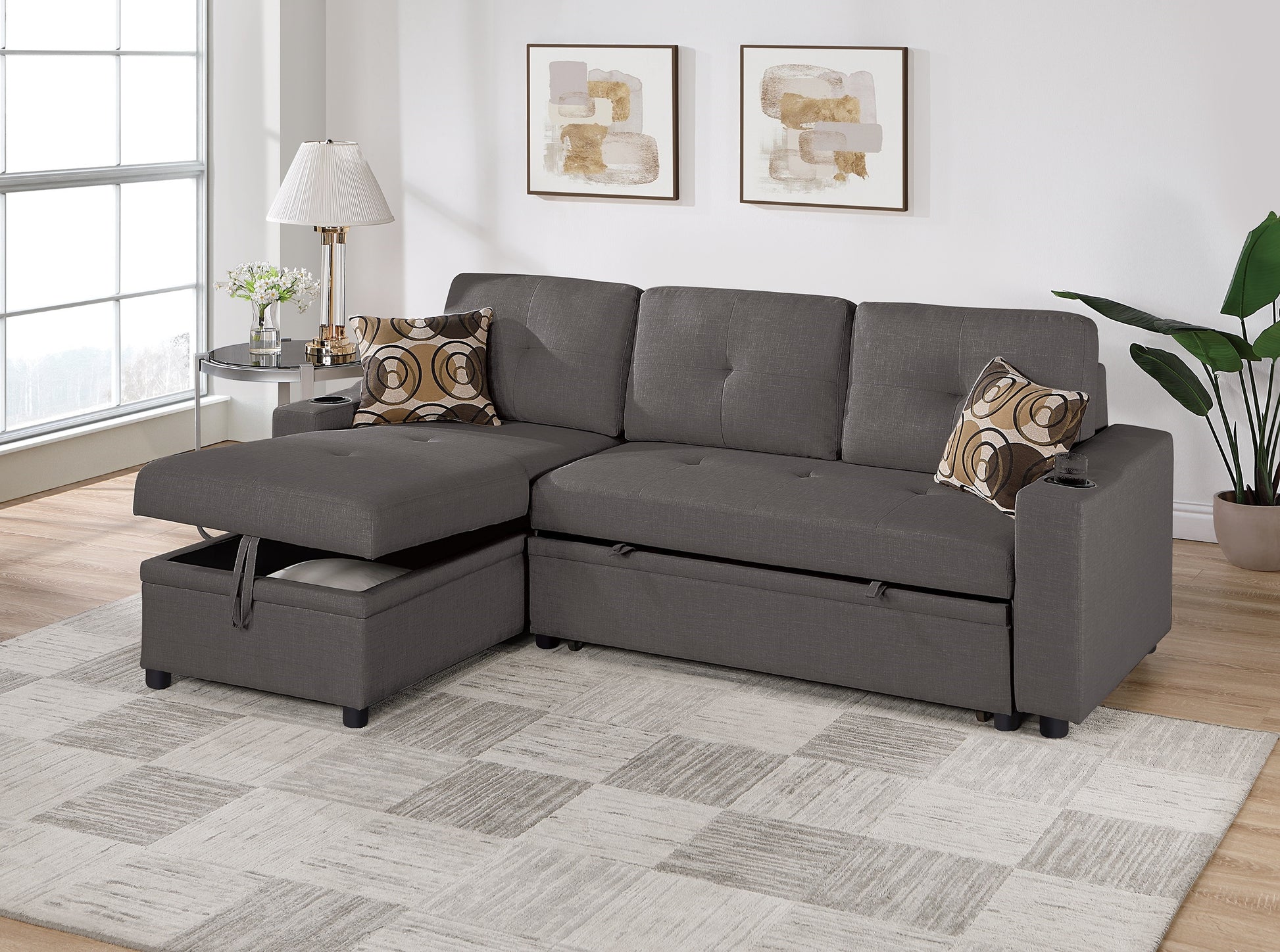 Dark gray sectional sofa with storage chaise featuring tufted back cushions and builtin cup holders