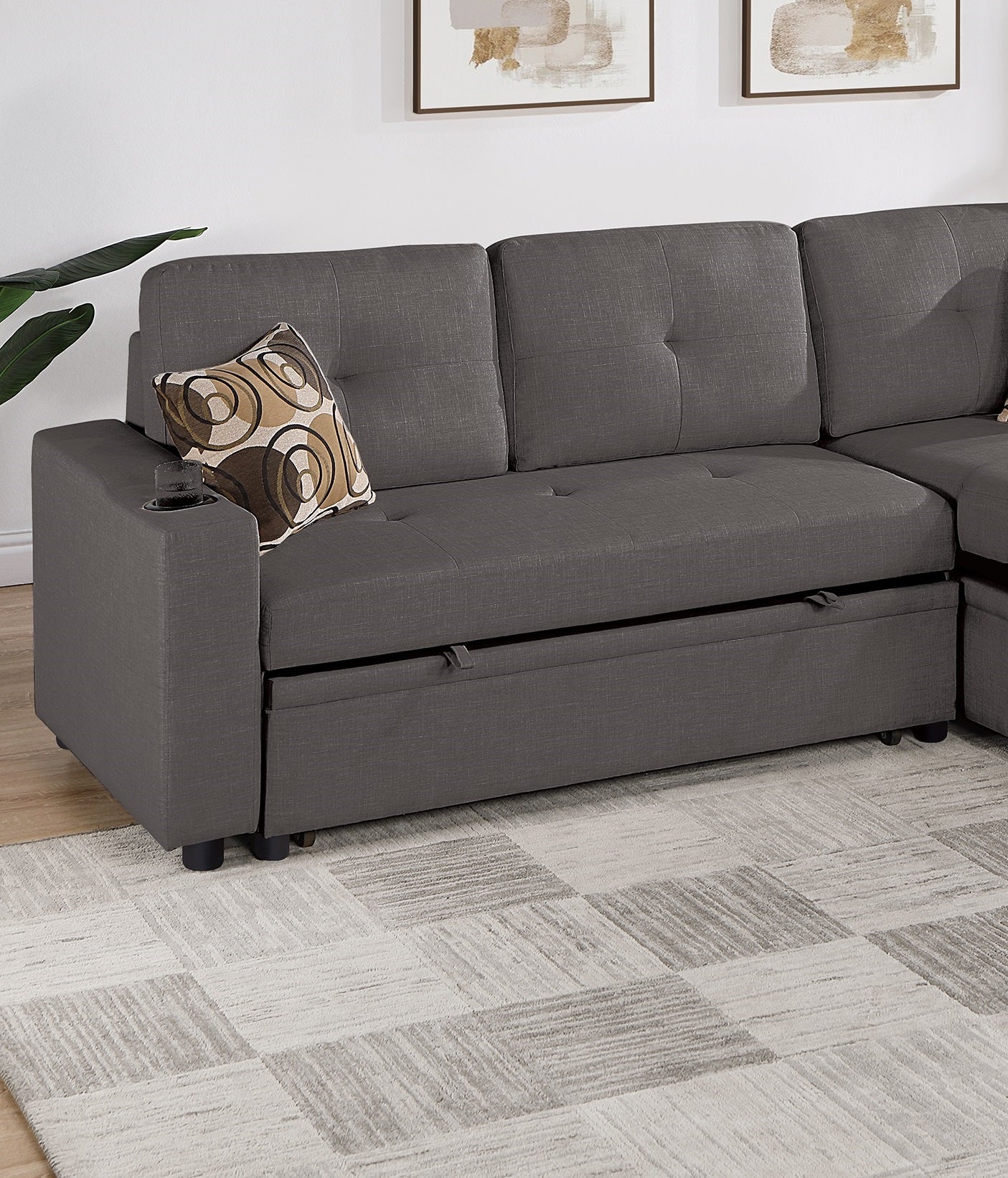 Dark gray fabric sectional sofa with pullout bed and integrated cup holder