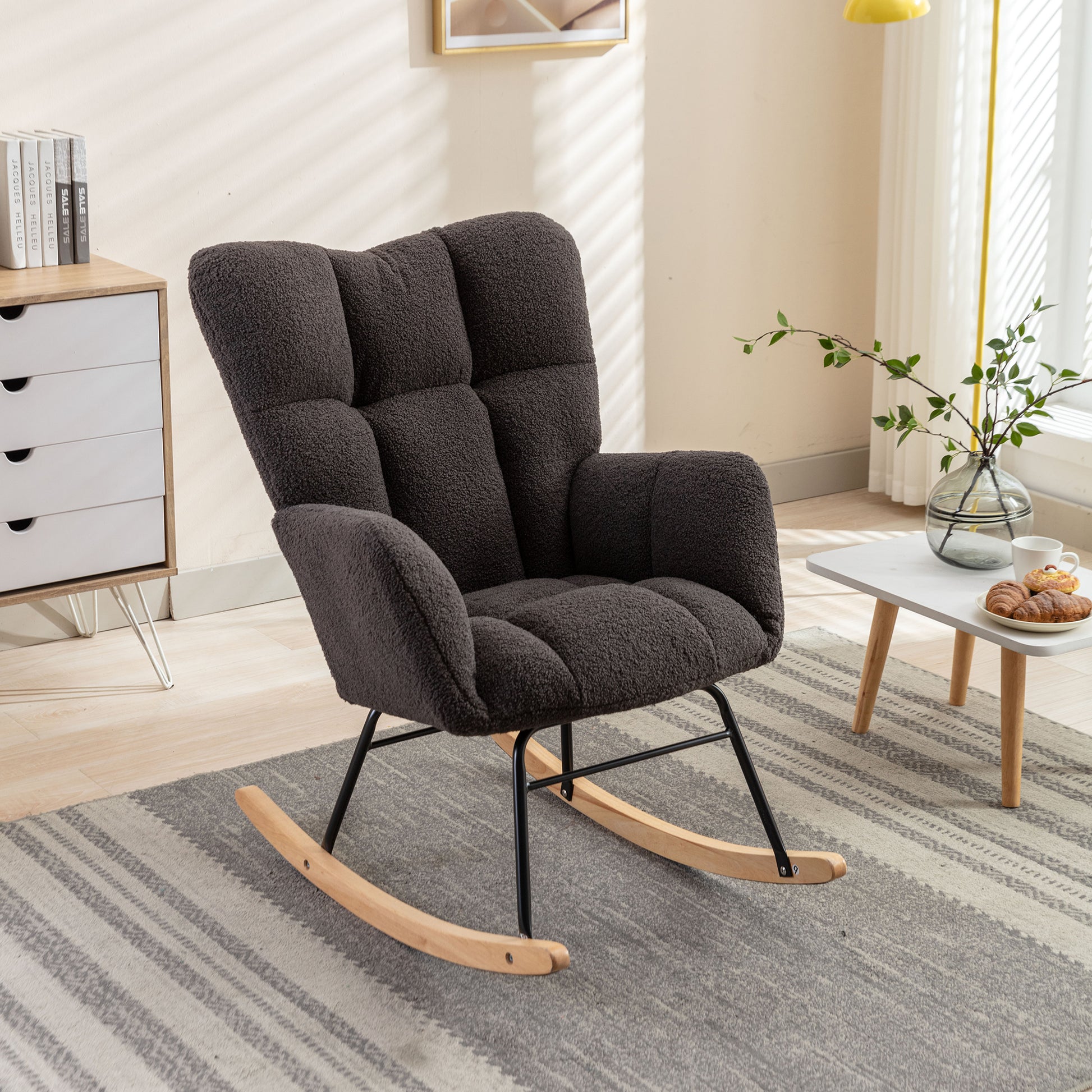 Dark gray plush rocking chair with tufted back and wooden rockers ideal for a cozy living room