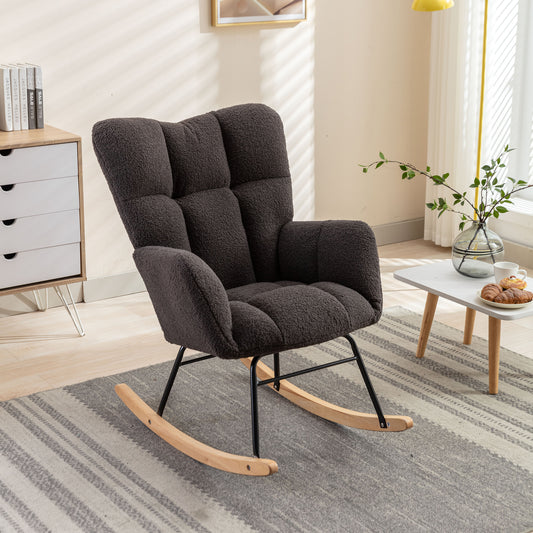Dark gray plush rocking chair with tufted back and wooden rockers ideal for a cozy living room