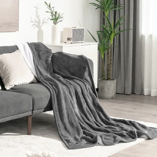 Plush grey fleece throw blanket draped over a sofa perfect for cozy home decor