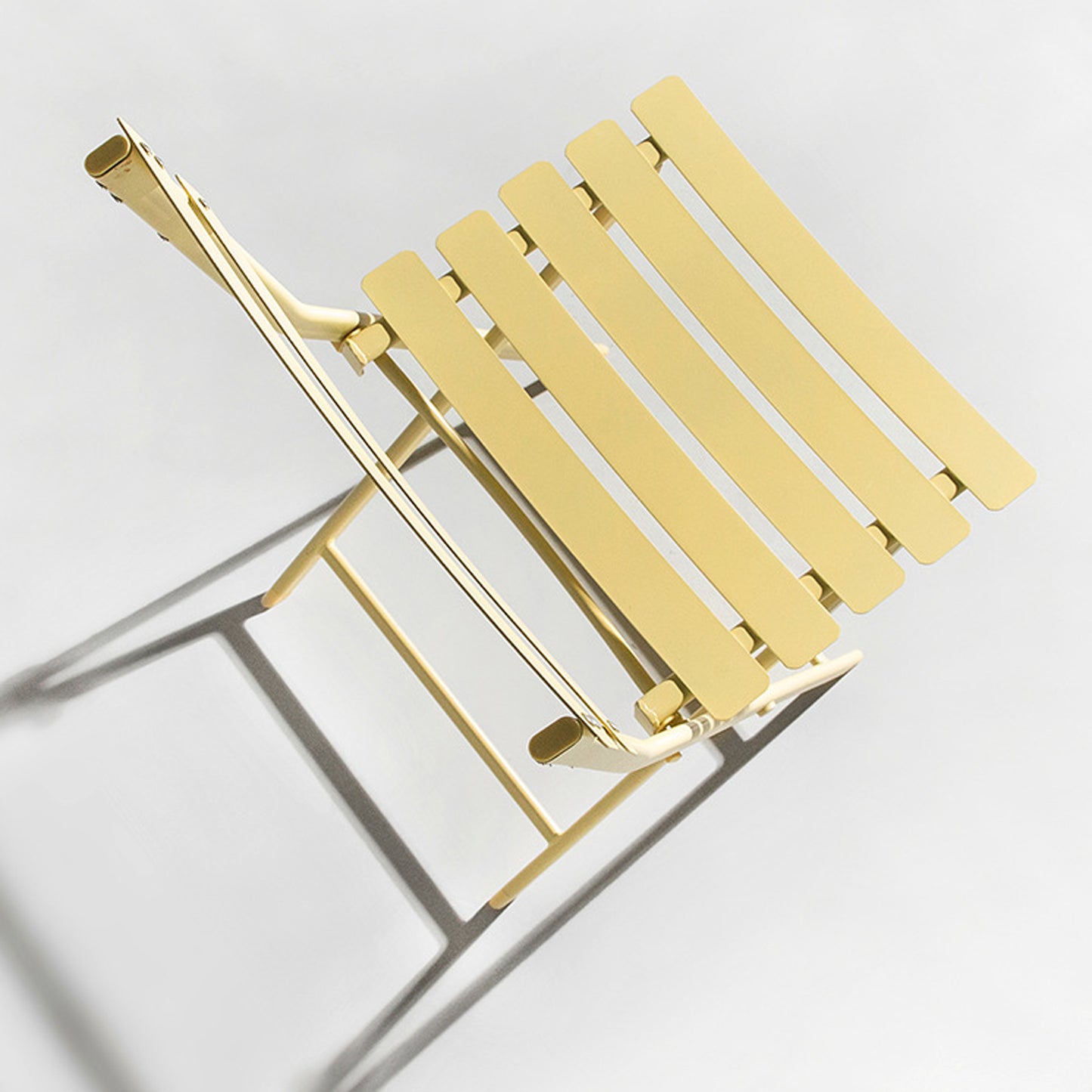 Yellow metal slatted folding chair perfect for outdoor patio seating