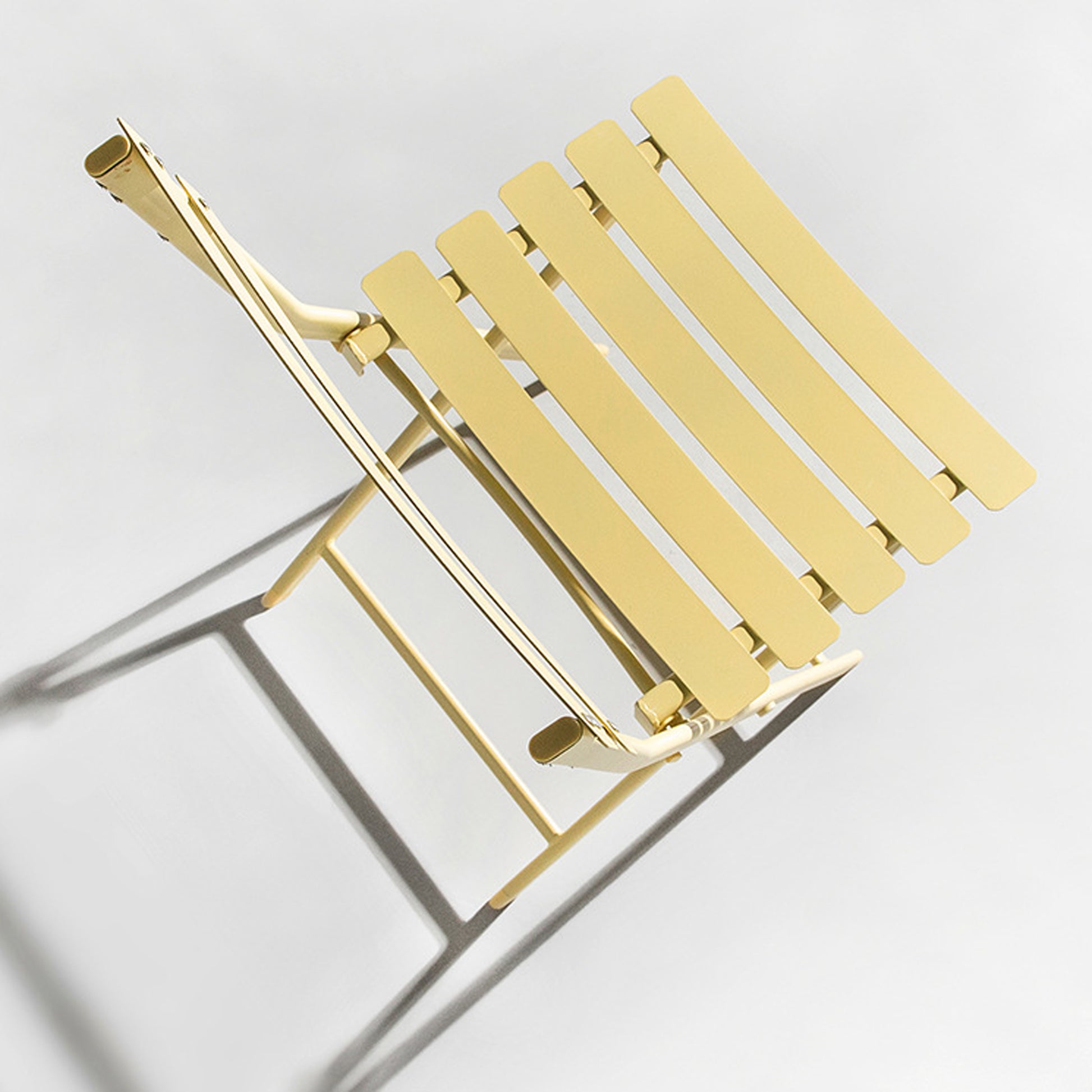 Yellow metal slatted folding chair perfect for outdoor patio seating
